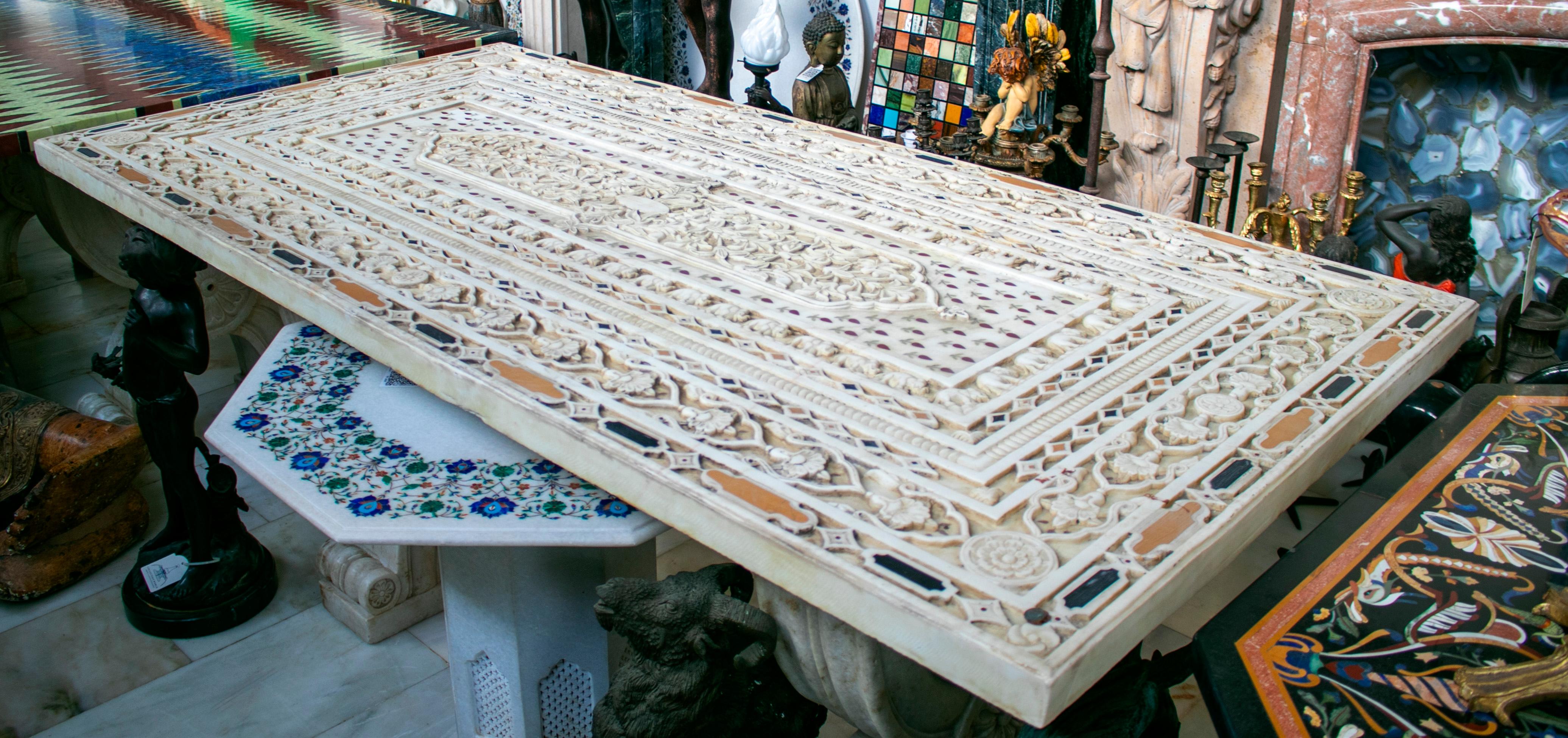 Rectangular Italian Pietre Dure technique handmade white marble inlay mosaic 6-seater dining tabletop. Profusely relieved with hand carved vegetative and animal motifs, such as elephants.