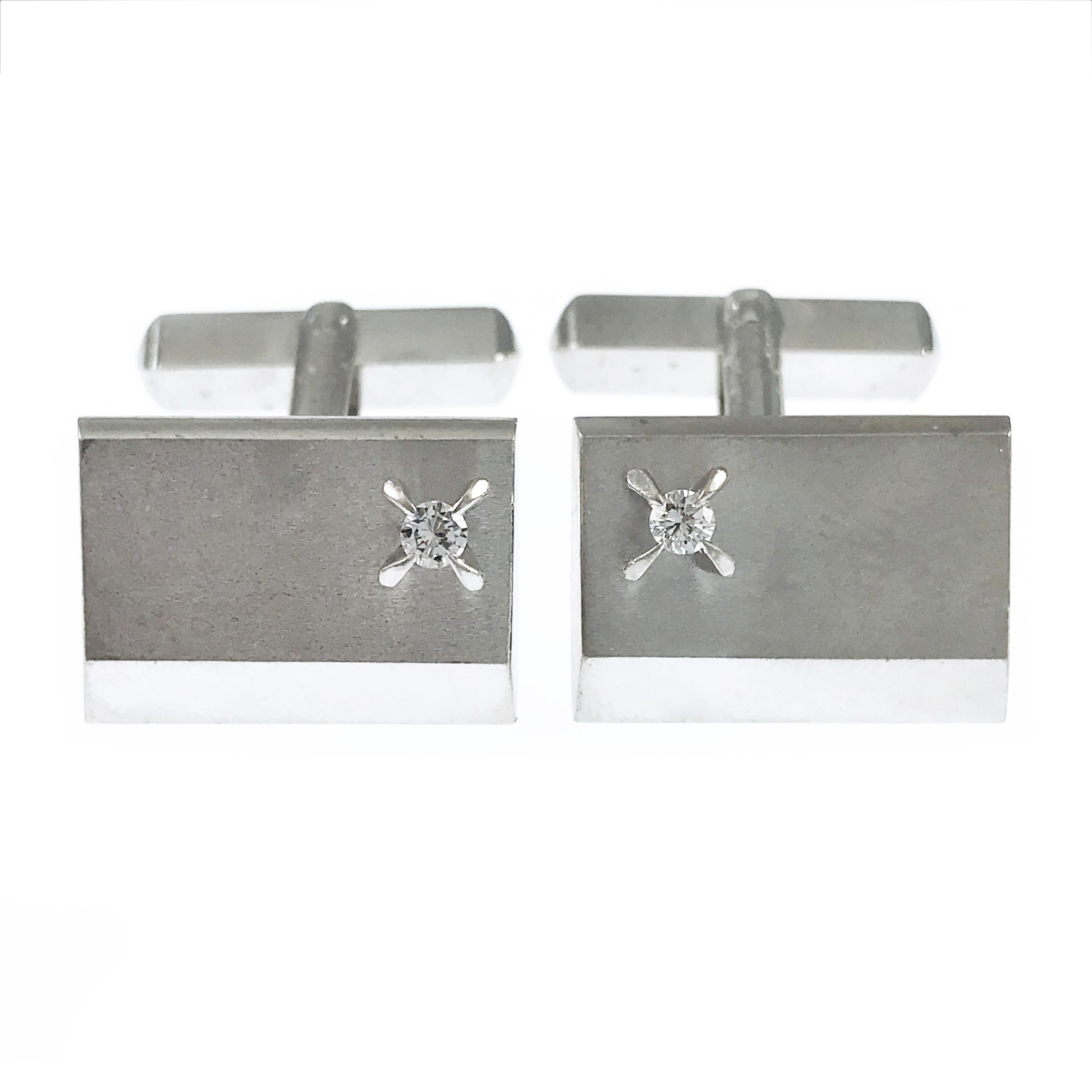 Platinum Diamond Cufflinks. A single 2.4 mm round diamond is set on one side of each of the cufflinks, the diamonds are VS (G.I.A.) in clarity and G-H (G.I.A.) in color. About three-quarters of the cufflink fronts are satin finish while the