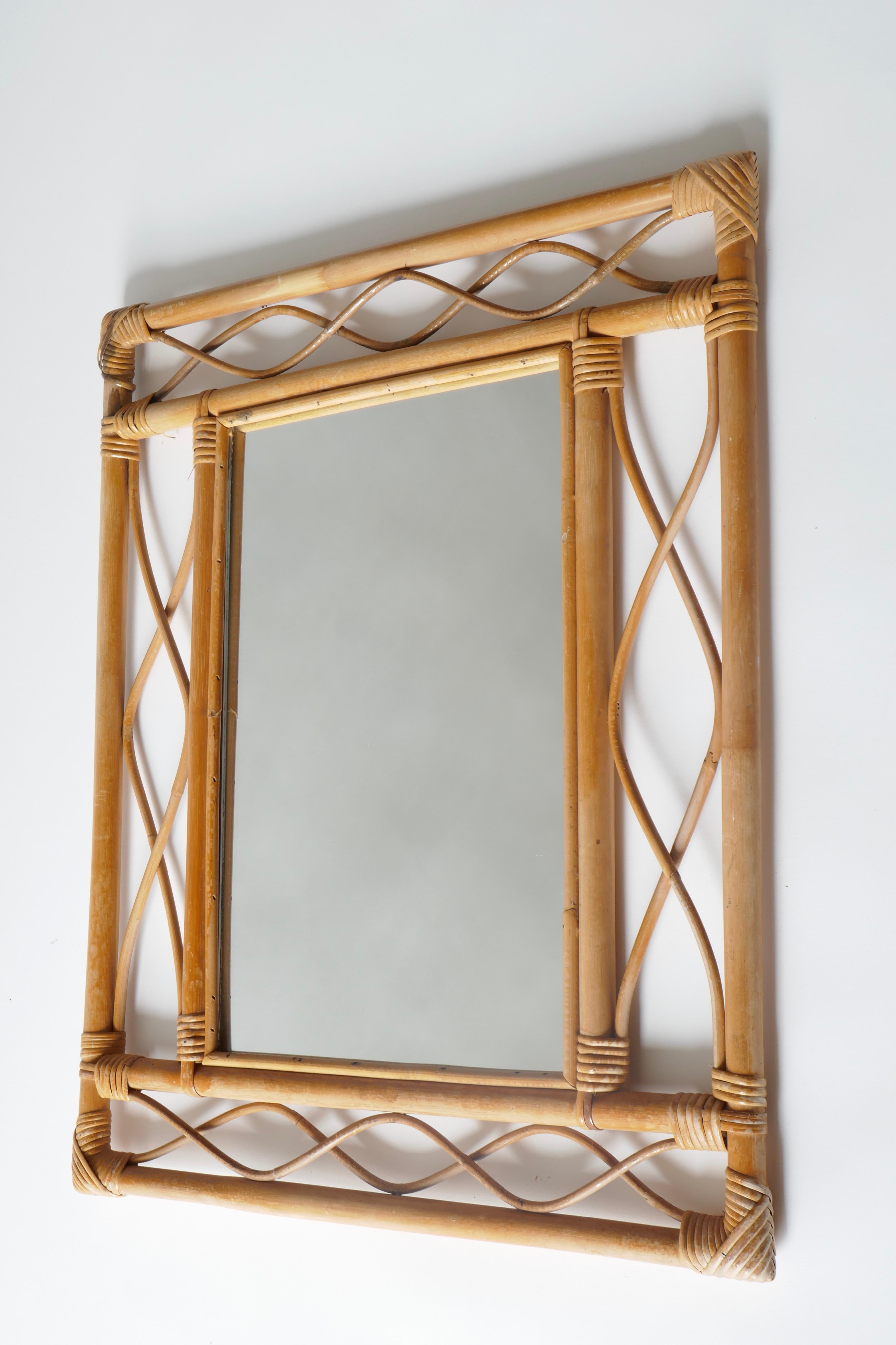 A delicate motif rattan mirror, France, 1960s
Here :
Measures: H66 x W56xD2cm

Also available in H 56 x W46cm.
 