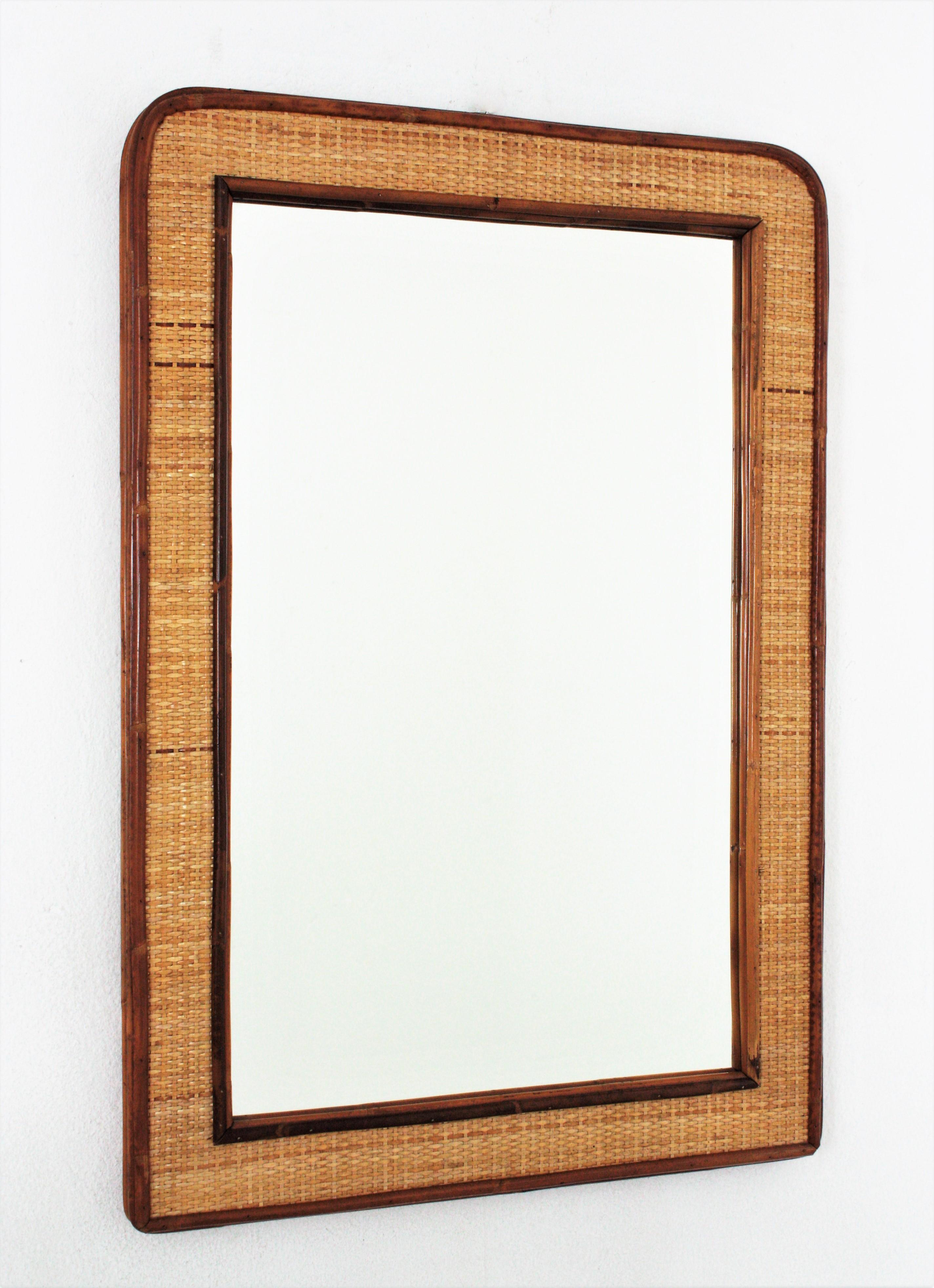 Large Rectangular Mirror in Rattan and Wicker, Italy, 1970s
Elegant mid-20th century period woven wicker and bamboo mirror.
This rattan / wicker rectangular mirror dates from the 1970s. A four layered dark rattan frame featuring a woven wicker