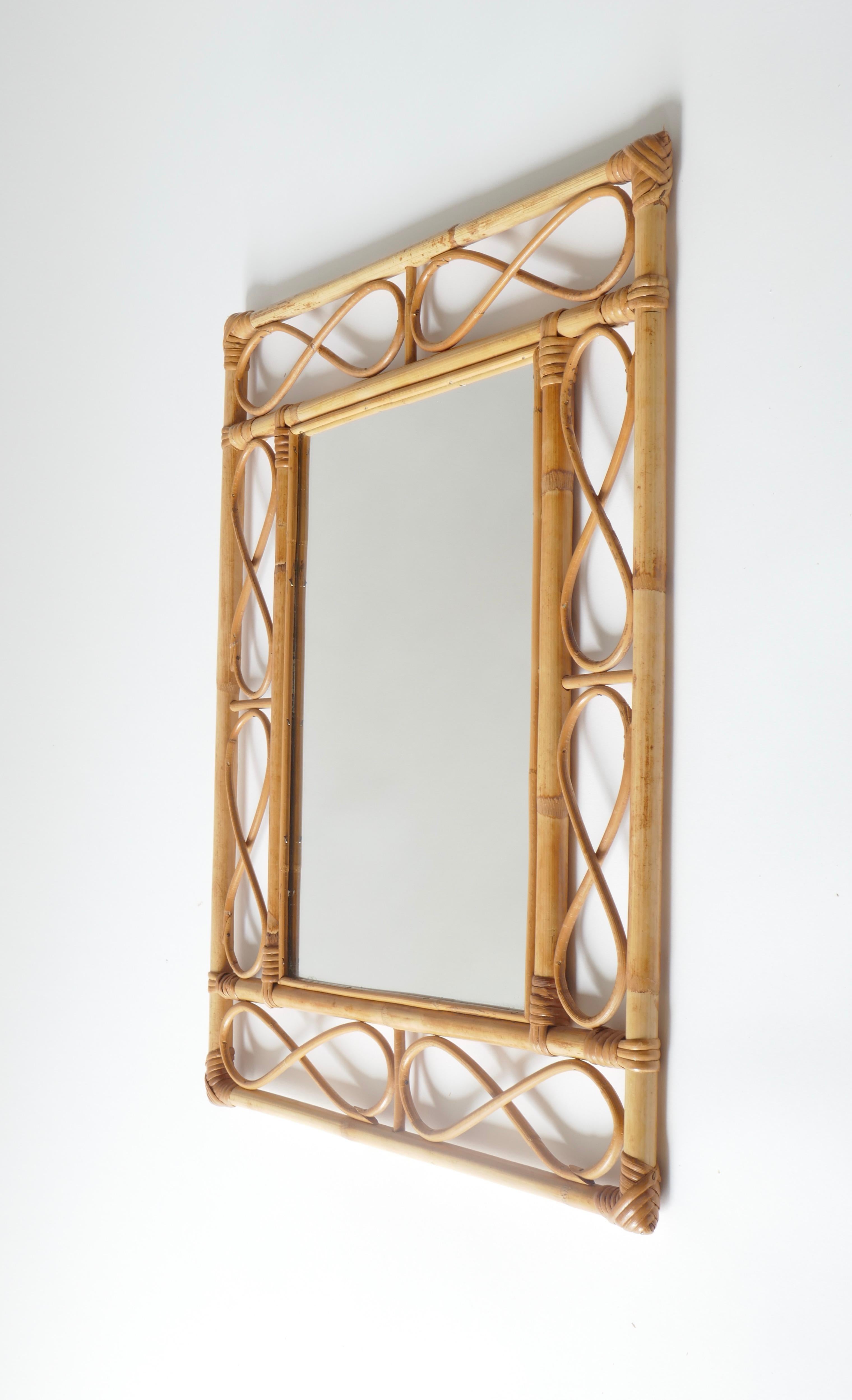 A delicate rattan motif mirror , France 1960s

This item is available in 2 sizes 

Here 
Measures: H 57cm x W 46cm x D 2cm



