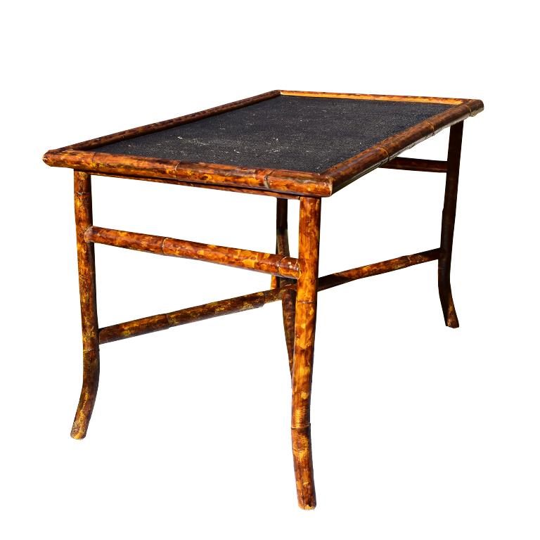 Tortoise shell or scorched bamboo coffee table. Beautiful rectangular coffee table with black woven cane or rattan top. Legs are splayed and are connected with a crossbar stretcher for added stability. At each end, an additional small piece of the