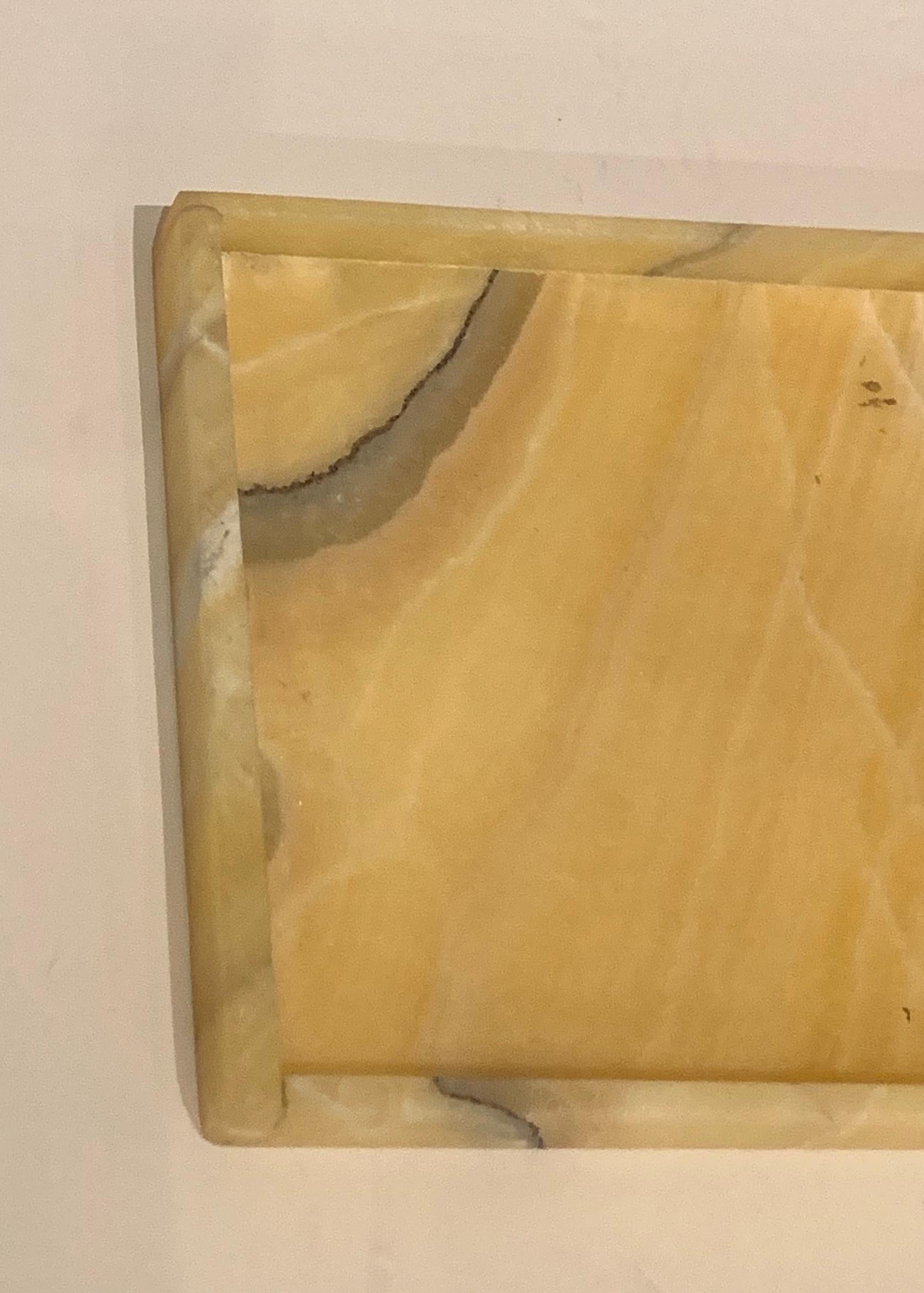 Rectangular shaped onyx tray with small lip border.
Gold in color with natural veins running through the onyx.