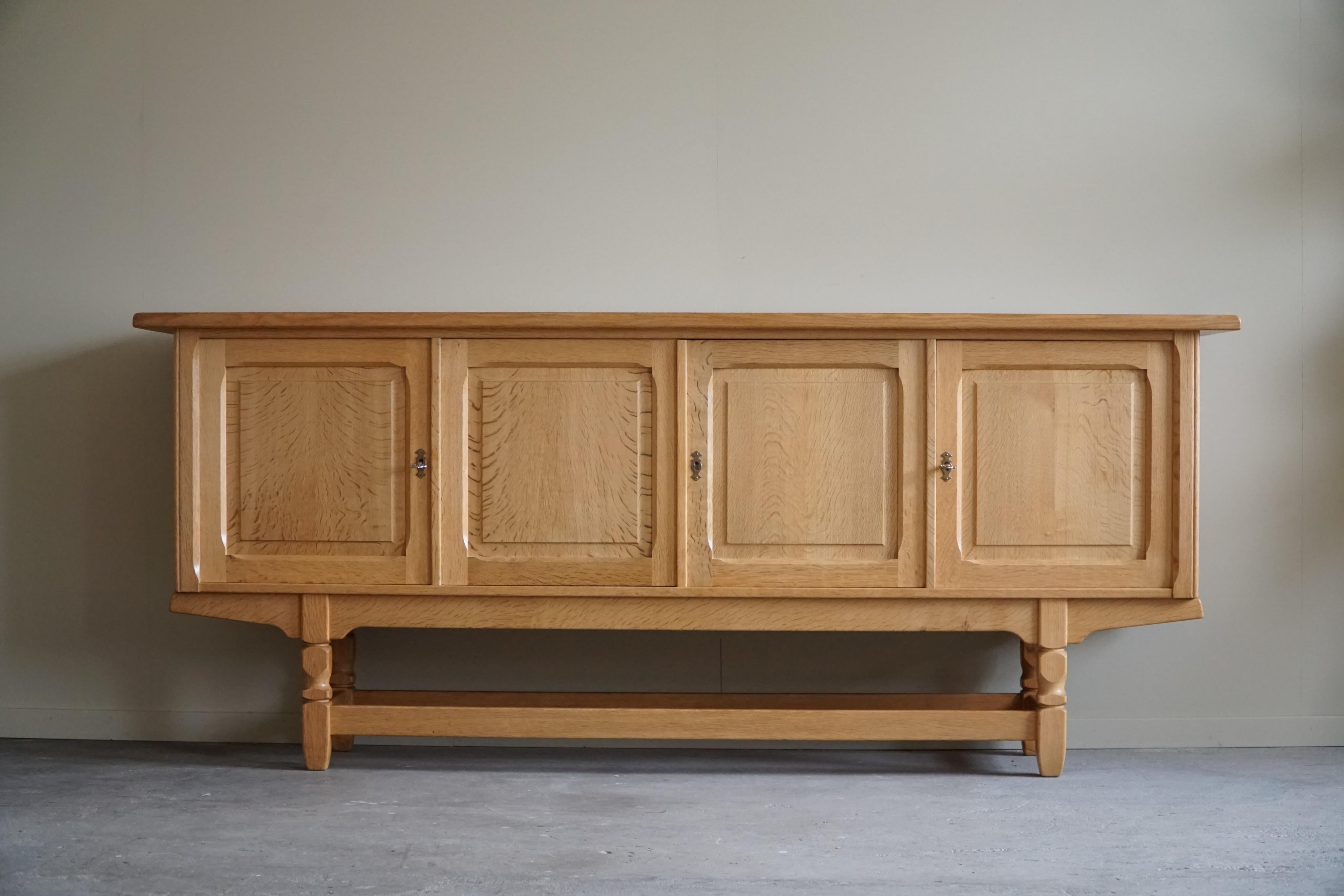 Beautiful low classic sideboard / cabinet in solid oak with plenty of storage space. Made by a Danish cabinetmaker in the 1960s. This piece is in a great vintage condition, with few signs of wear.

This brutalist object will fit into many interior