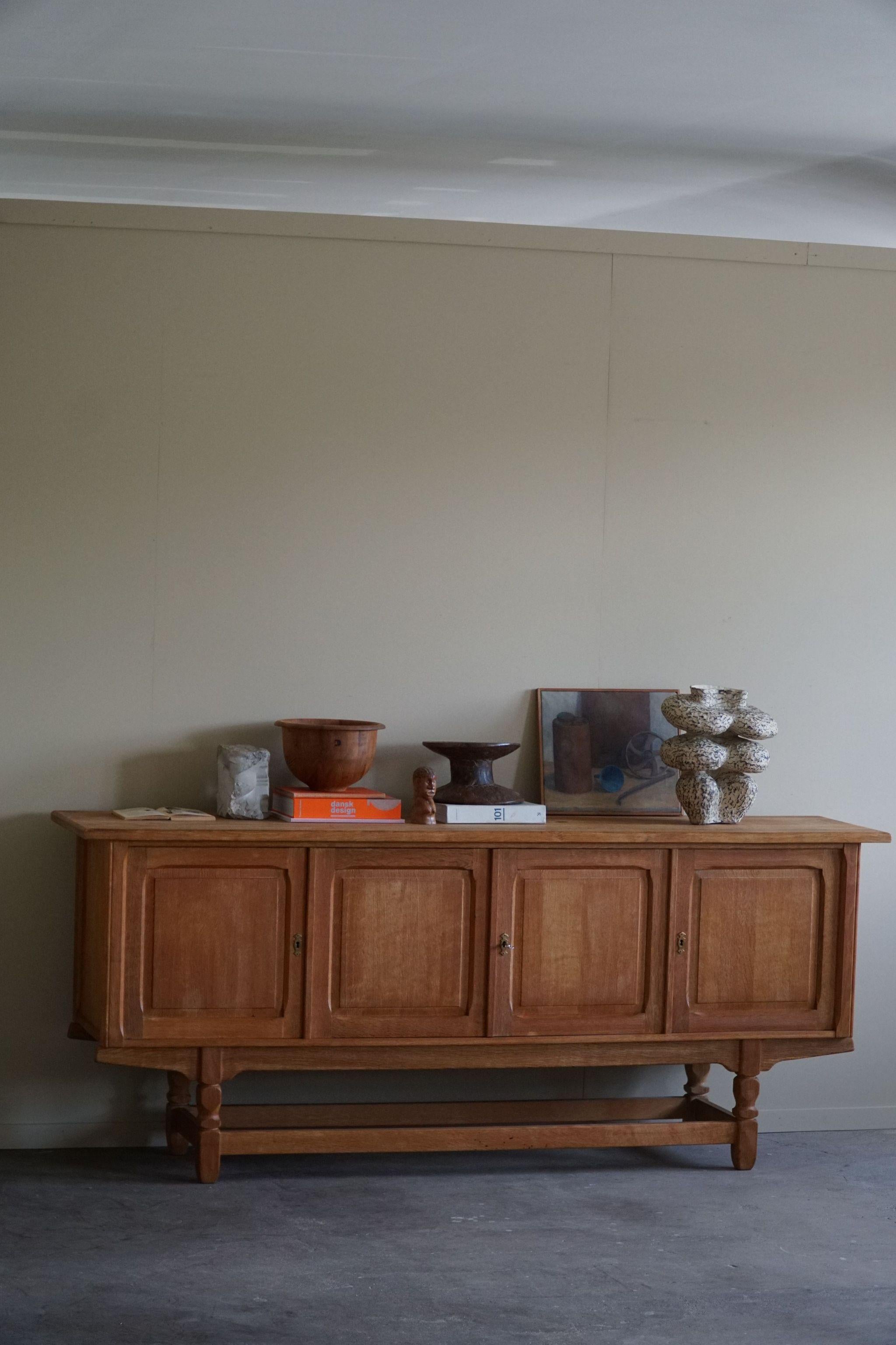 Beautiful low classic sideboard / cabinet in solid oak with plenty of storage space. Made by a Danish cabinetmaker in the 1960s.

This brutalist object will fit into many interior styles. A modern, Scandinavian, Classic or an Art Deco home