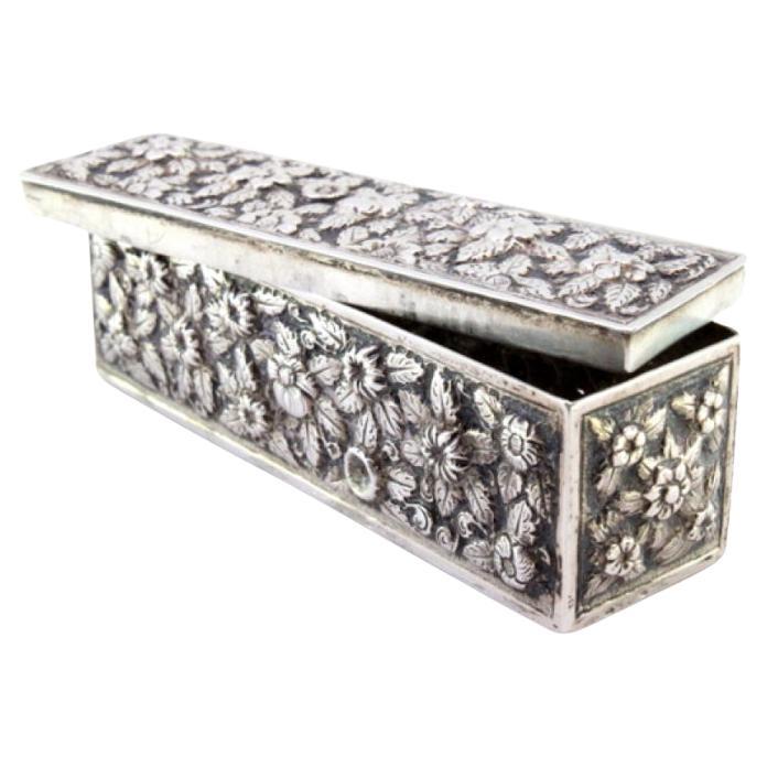 Rectangular silver box with raised floral motifs