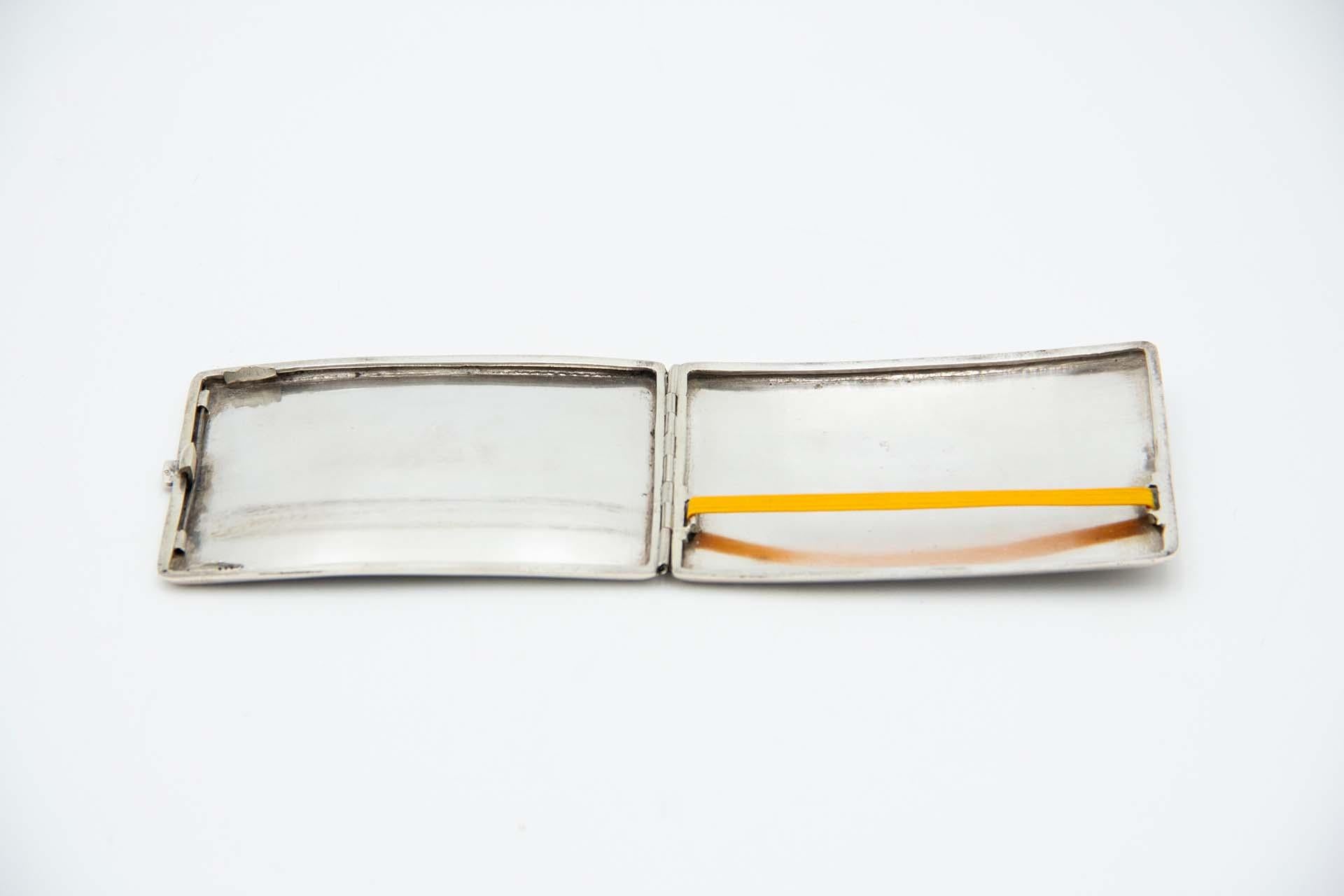 Description: Silver cigarette case in rectangular shape with Arabic-style relief on the lid and back with Islamic symbols. Metal: Silver. Origin: French. Brand: Cisne. Weight: 144.24 grams. Dimensions: 11.2cmx0.9cm. Content: 900/1000. Assay Mark: