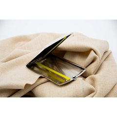 Rectangular silver case with lengthwise strips and spring-loaded lid