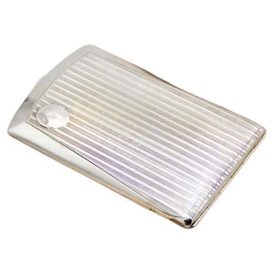 Rectangular silver case with lengthwise strips and spring-loaded lid