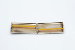 Rectangular silver case with raised bands, monogram insert and gold interior