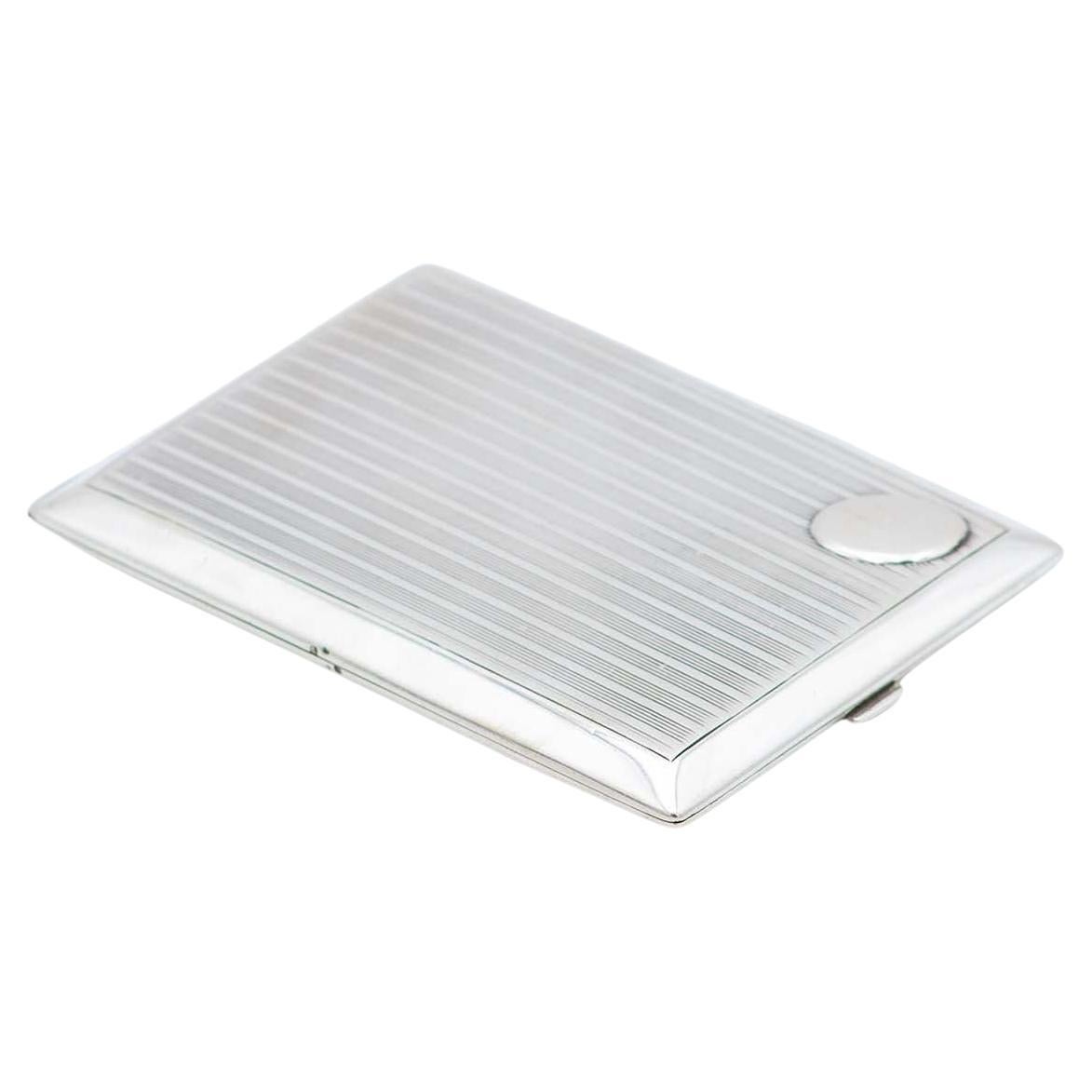 Rectangular silver case with raised bands, monogram insert and gold interior