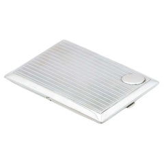 Rectangular silver case with raised bands, monogram insert and gold interior