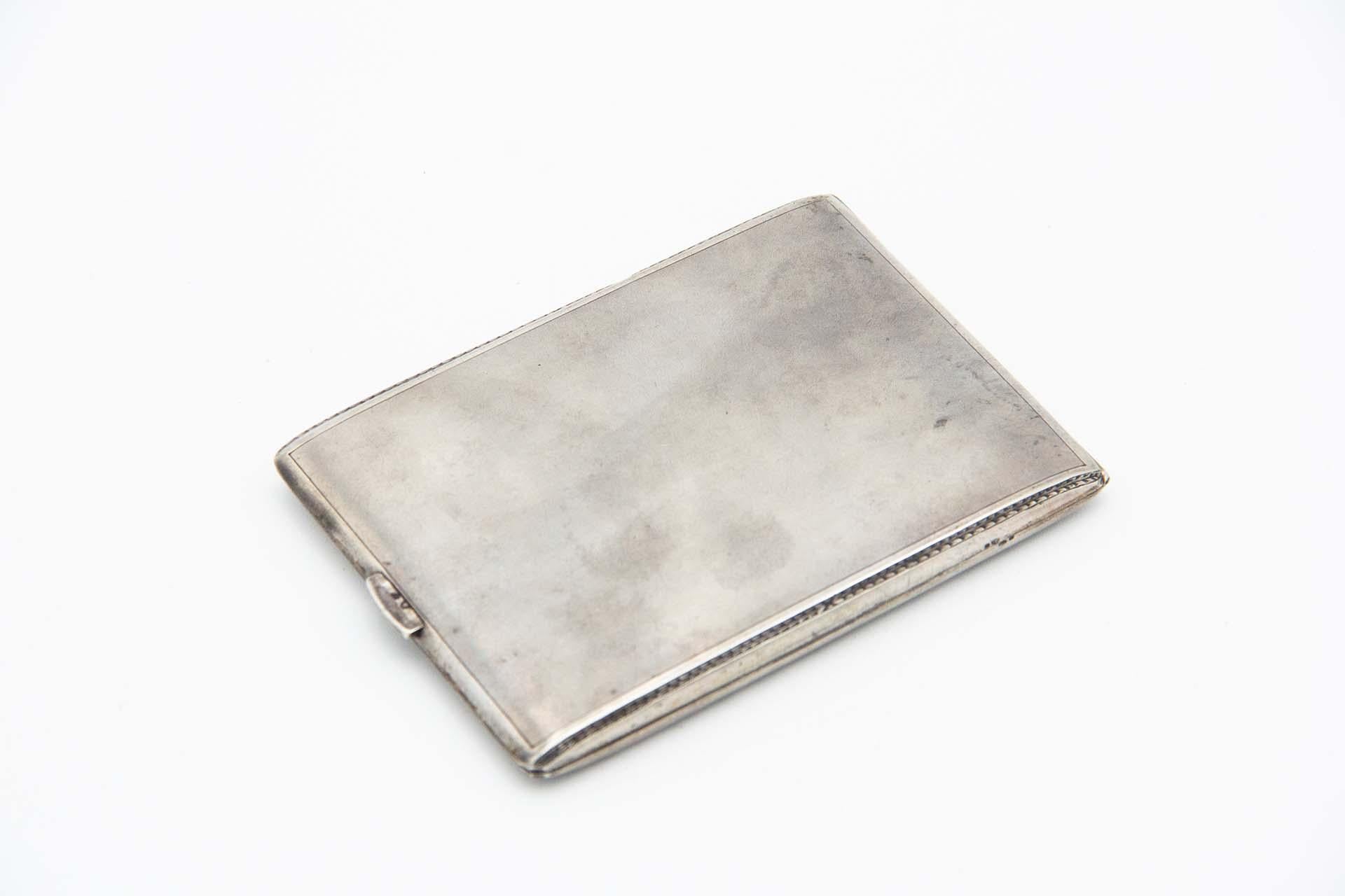 Description: Rectangular silver cigarette case with brushed finish and hinged lid. Metal: Silver. Origin: Portuguese. Brand: Cabeça de escravo. Weight: 92.50 grams. Dimensions: 11cm x 1cm. Content: 833/1000. Assay Mark: Yes, between 1938 and 1984.