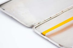 Rectangular silver cigarette case with crimped bands at the top and a hinged lid
