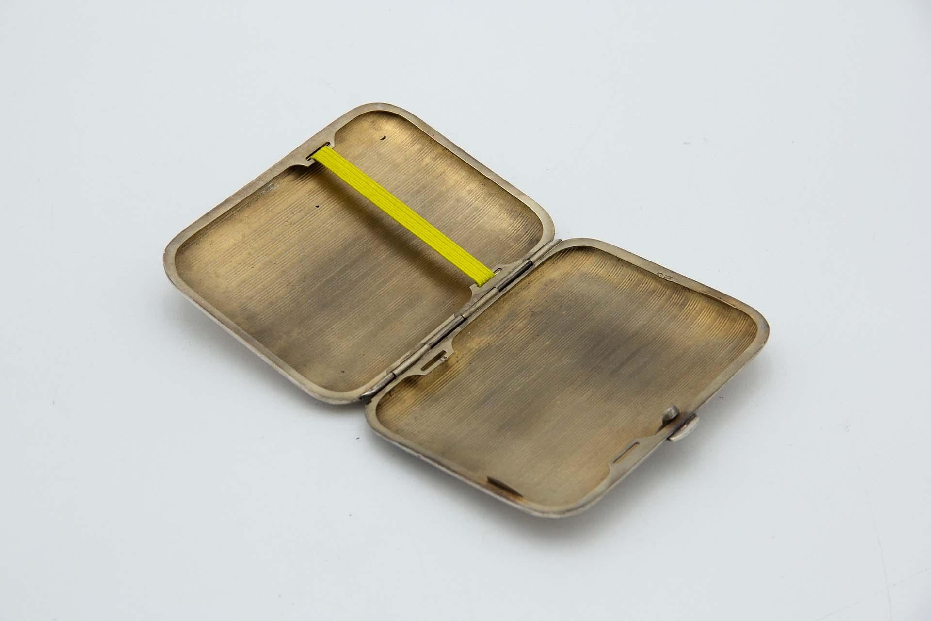 Description: Rectangular silver cigarette case with rounded corners and guilloche bands at the top. Metal: Silver. Origin: European. Brand: Unknown. Weight: 96.90 grams. Dimensions: 10cmx1.5cm. Content: 800/1000. Assay Mark: Yes. Additional