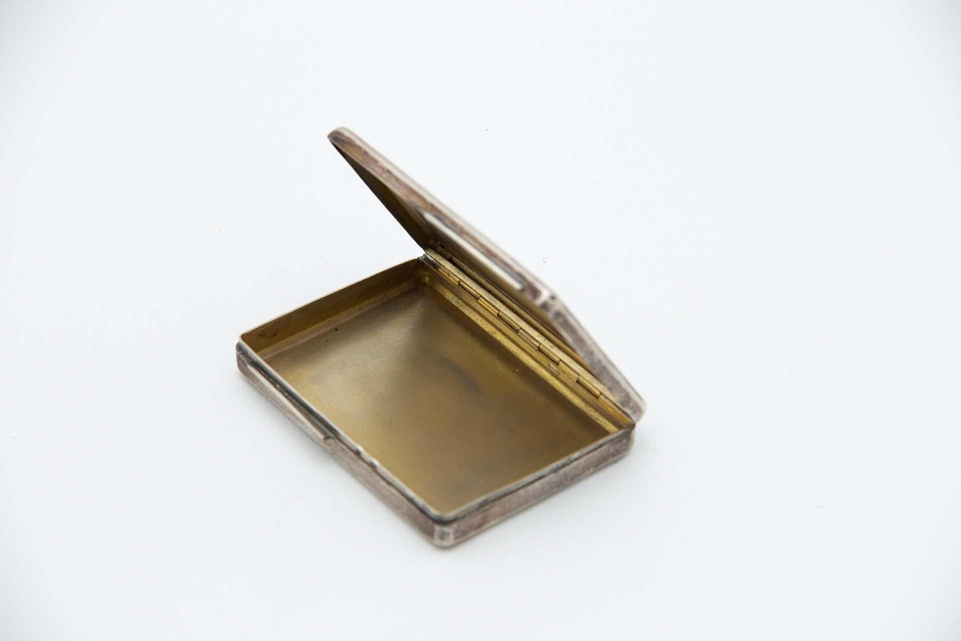 Description: Rectangular silver snuff box with engraved plant elements and gold interior. Metal: Silver. Origin: Austro-Hungarian. Brand: Pest. Weight: 53.40 grams. Dimensions: 7.3cmx1.2cm. Content: 800/1000. Assay Mark: Yes, 1867. Additional