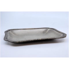 Rectangular silver tray with silver-cut corners and rim with raised friezes