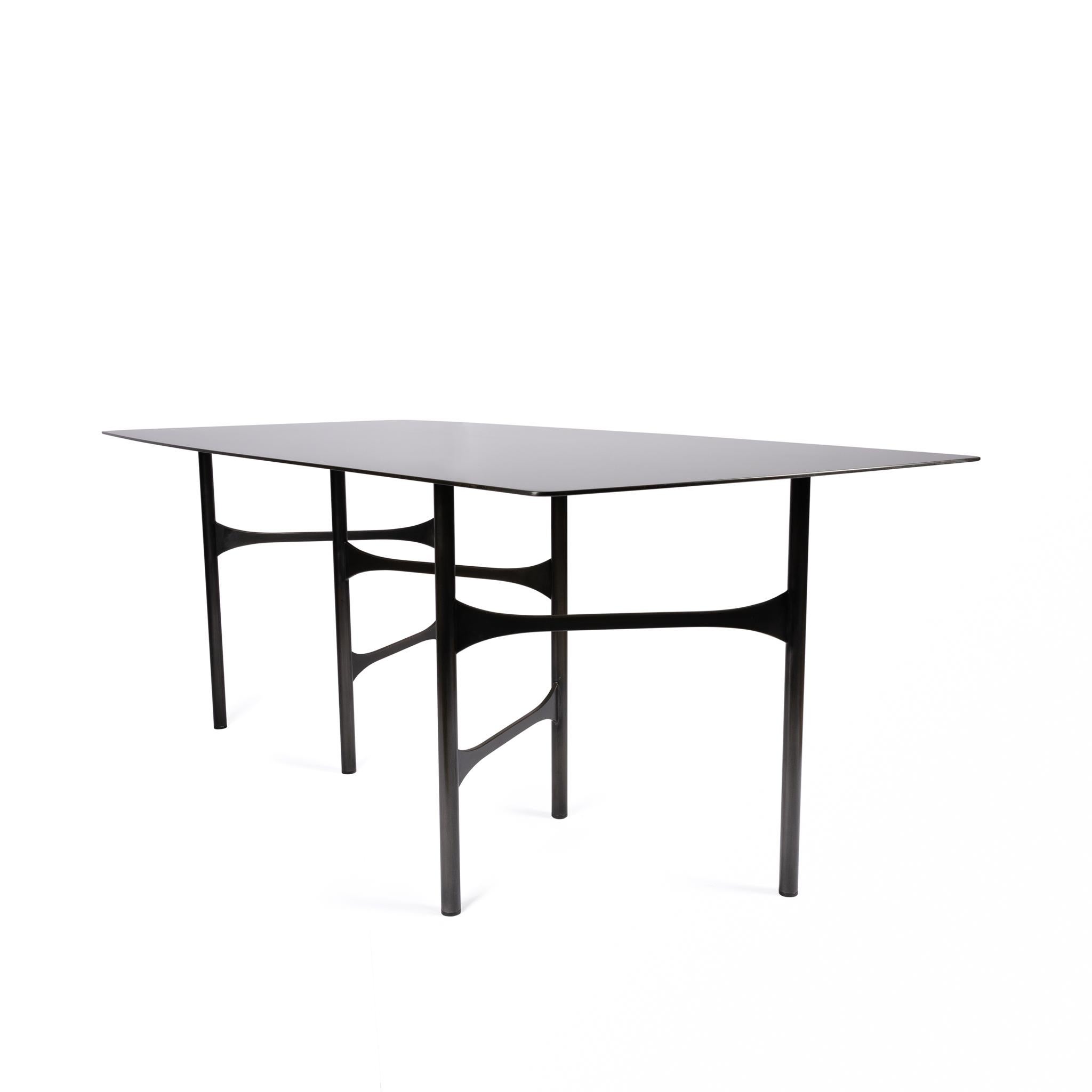 Blending contemporary and organic influences, the Strut Table was designed as an eye-catching table. Its subtle details and a hand applied finish makes the Strut Table a striking piece for any environments. It's metal table top hand finish,
