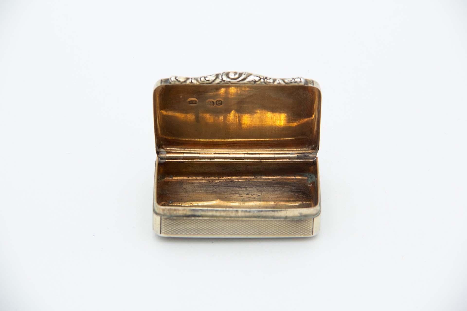 Description: Rectangular snuff box in guilloche silver and relief on the hinged lid. Metal: Silver. Origin: English. Brand: London. Weight: 48.54 grams. Dimensions: 6.3cmx1.8cm. Content: 925/1000. Assay Mark: Yes, 1820 by Charles Reeves. Additional