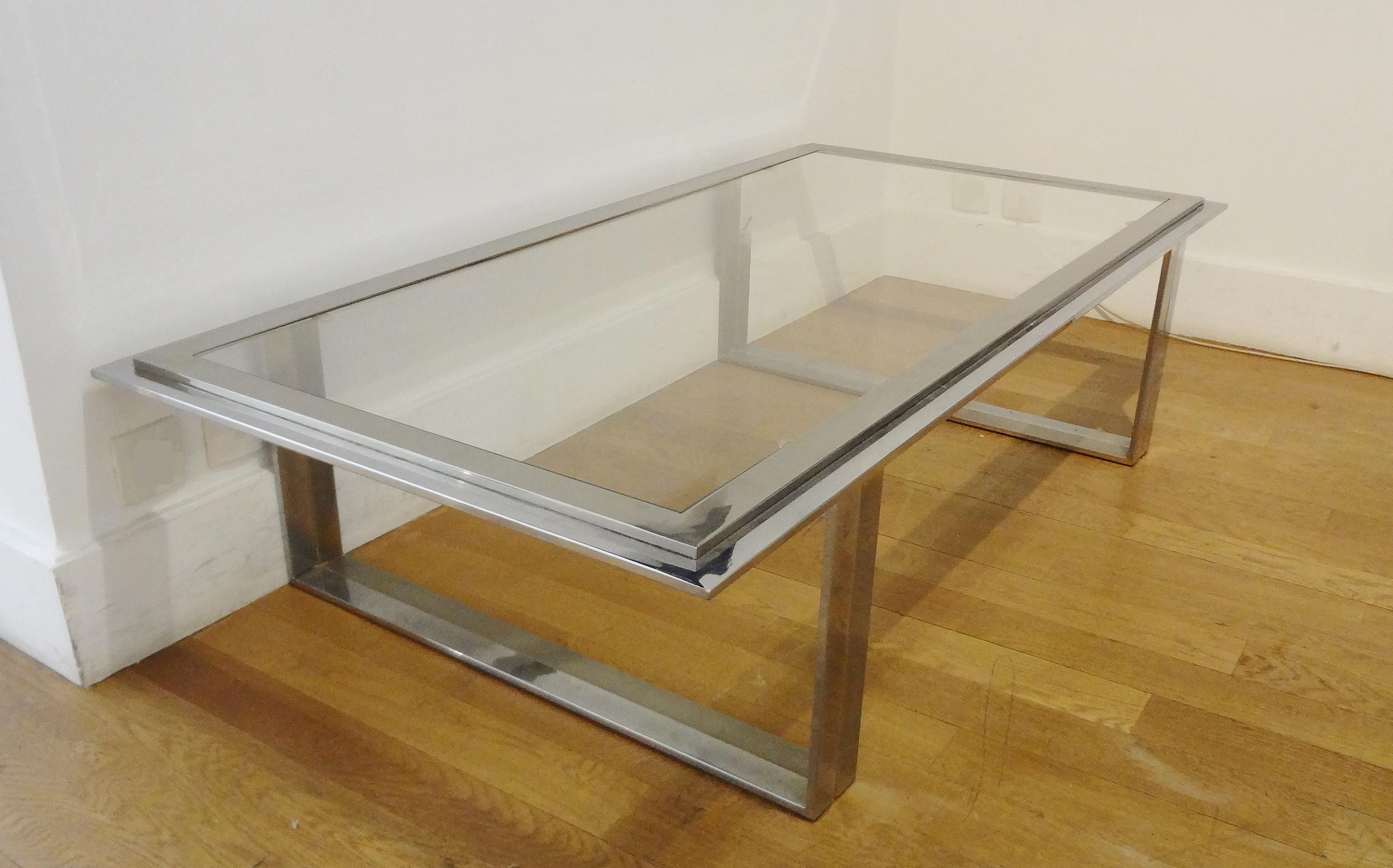 Large rectangular chromed and mate light gilt steel coffee table by Romeo Rega, Italy, 1970s.
With a light grey smoky glass top. Two U bases. 
Harmonious wide proportions.
Glass dimensions : 130 x 60 cm. 
 