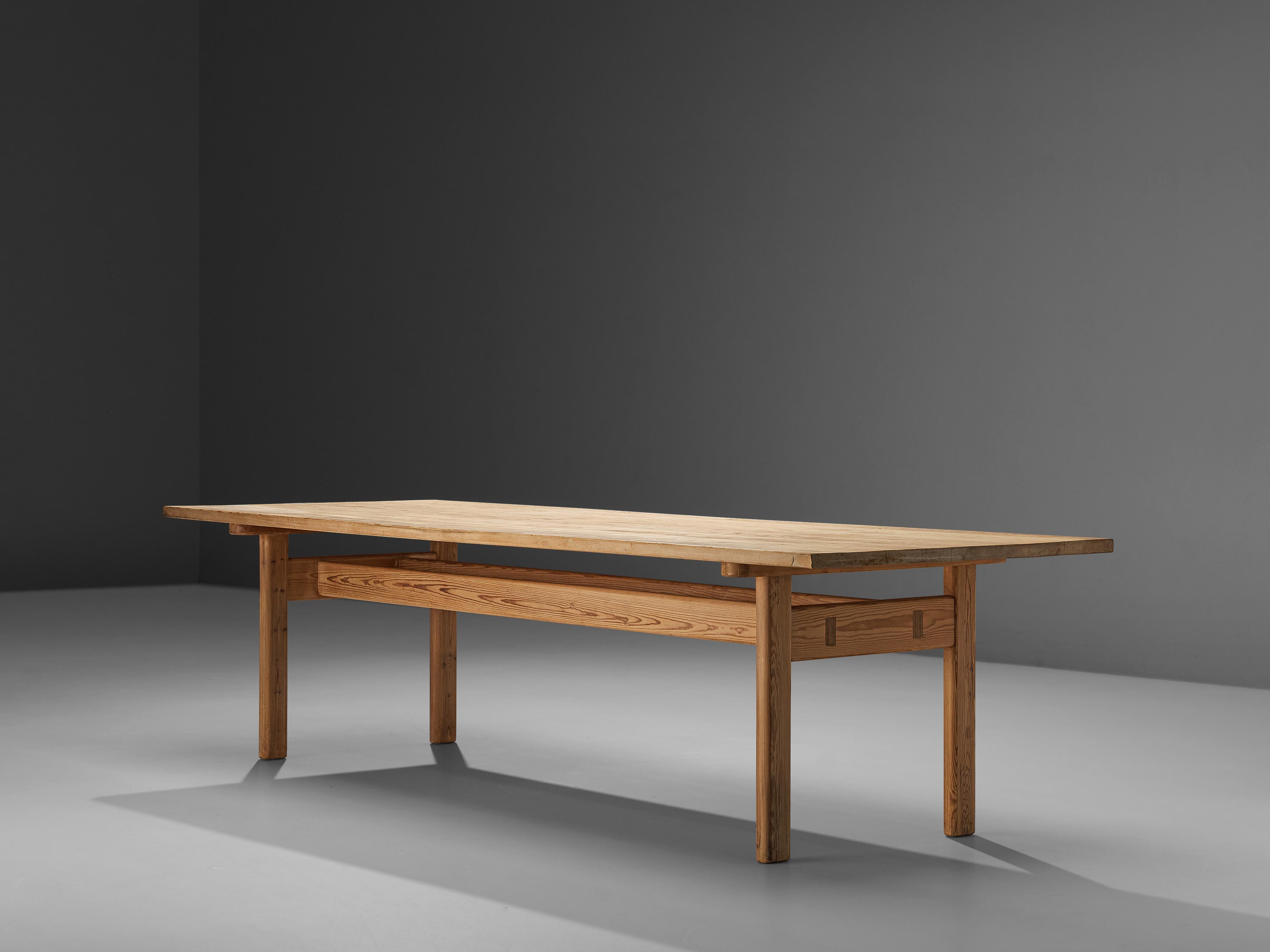 Rectangular dining table, pine, Sweden, 1960s

With the expressive grain of the pine this table has warm, natural character. The rectangular top rests on four legs. The legs as well are their interconnective slats have a flat shape. Due to its width