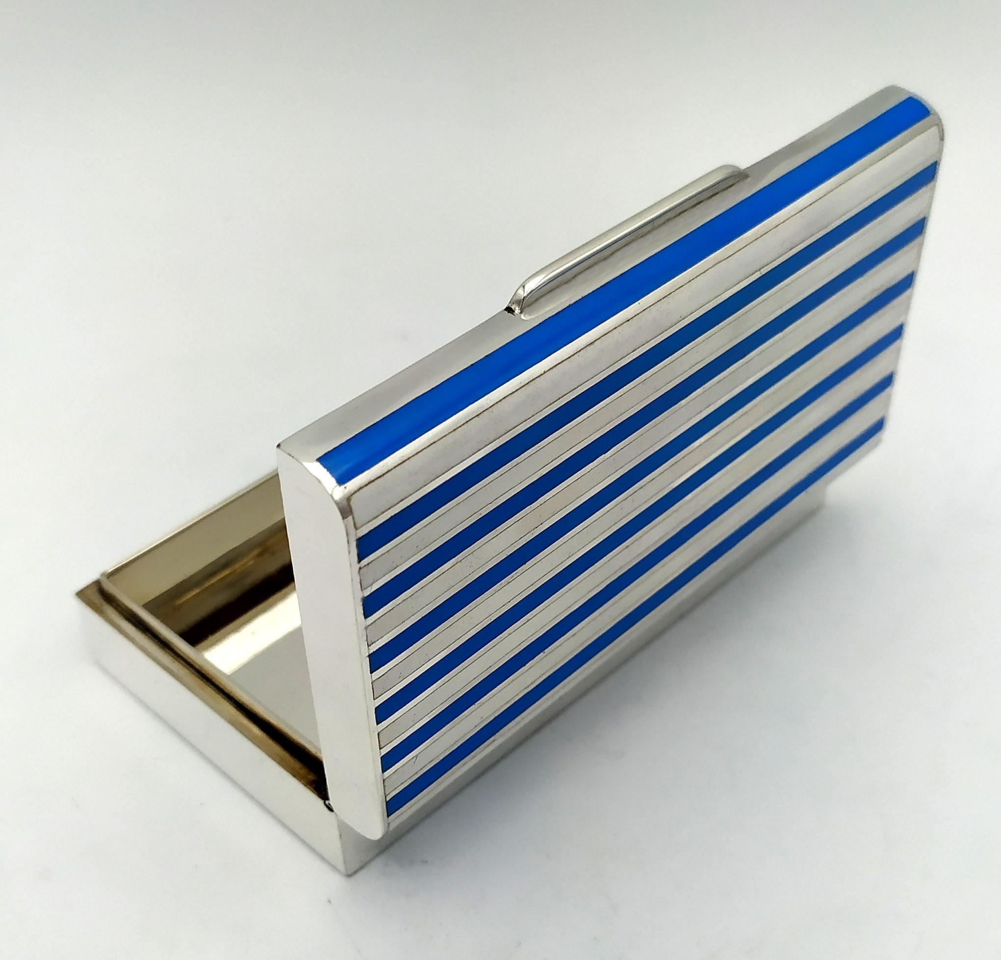Rectangular table cigarette case with rounded upper long sides, in 925/100 sterling silver and two-tone fire-enamelled stripes in a modern contemporary style. Dimensions cm. 6 x 10.5 x 2.5. Weight gr. 282. Designed by Franco Salimbeni in 1975 and