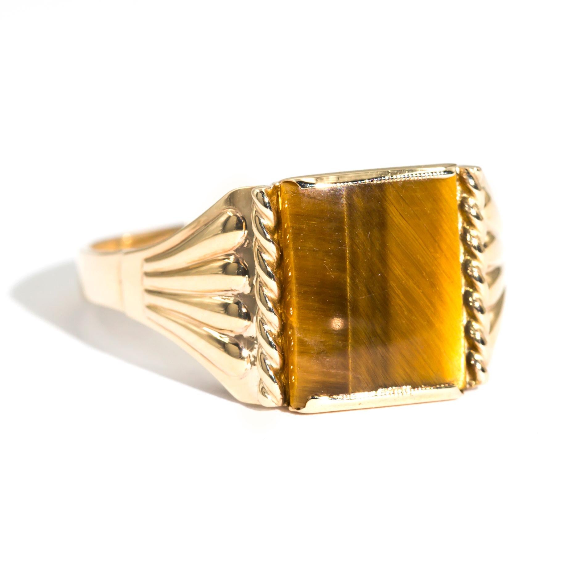 Crafted in 9 carat yellow gold is this handsome vintage mens signet ring featuring a charming 11.8x10 millimetre Tigers Eye seamlessly flowing down with pleated pattern sides. We have named this dapper vintage piece The Darcy Ring. The Darcy Ring