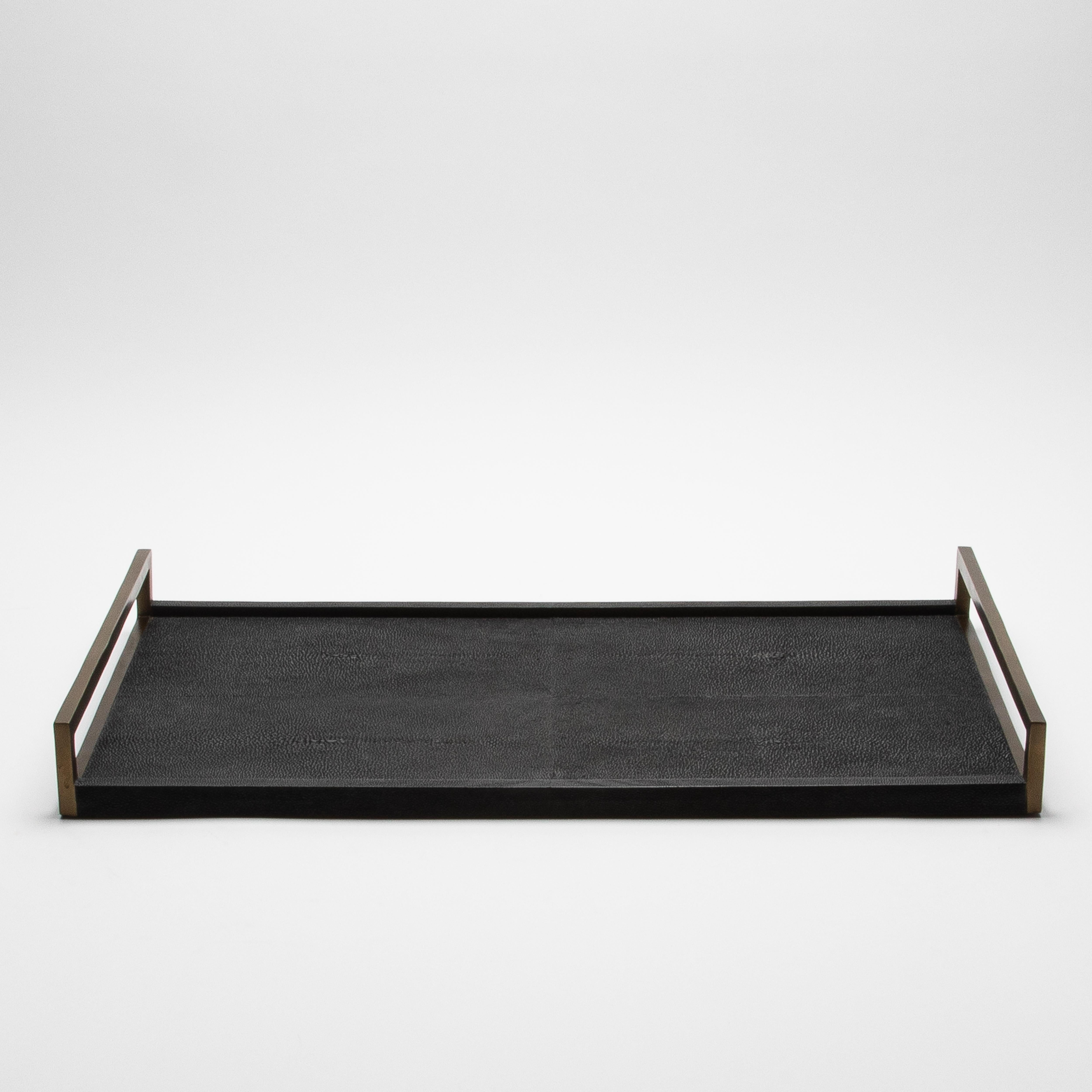 This elegant rectangular tray by R&Y Augousti is a stunning display of luxurious craftsmanship. With its sleek black shagreen surface, it exudes sophistication, while the contrasting bronze patina brass handles add a touch of opulence. Every detail