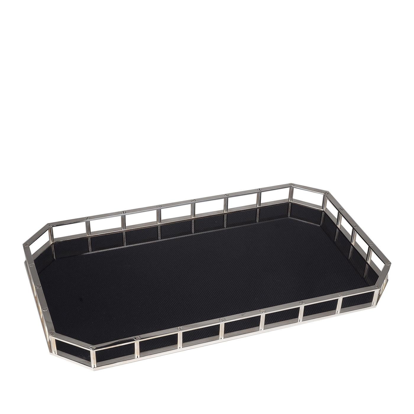 Elegant and modern, this tray is crafted in the shape of an octagon with two elongated sides that gives it a rectangular silhouette. The bottom is entirely lined with carbon fiber whose black tones are a sophisticated backdrop for its silver plated