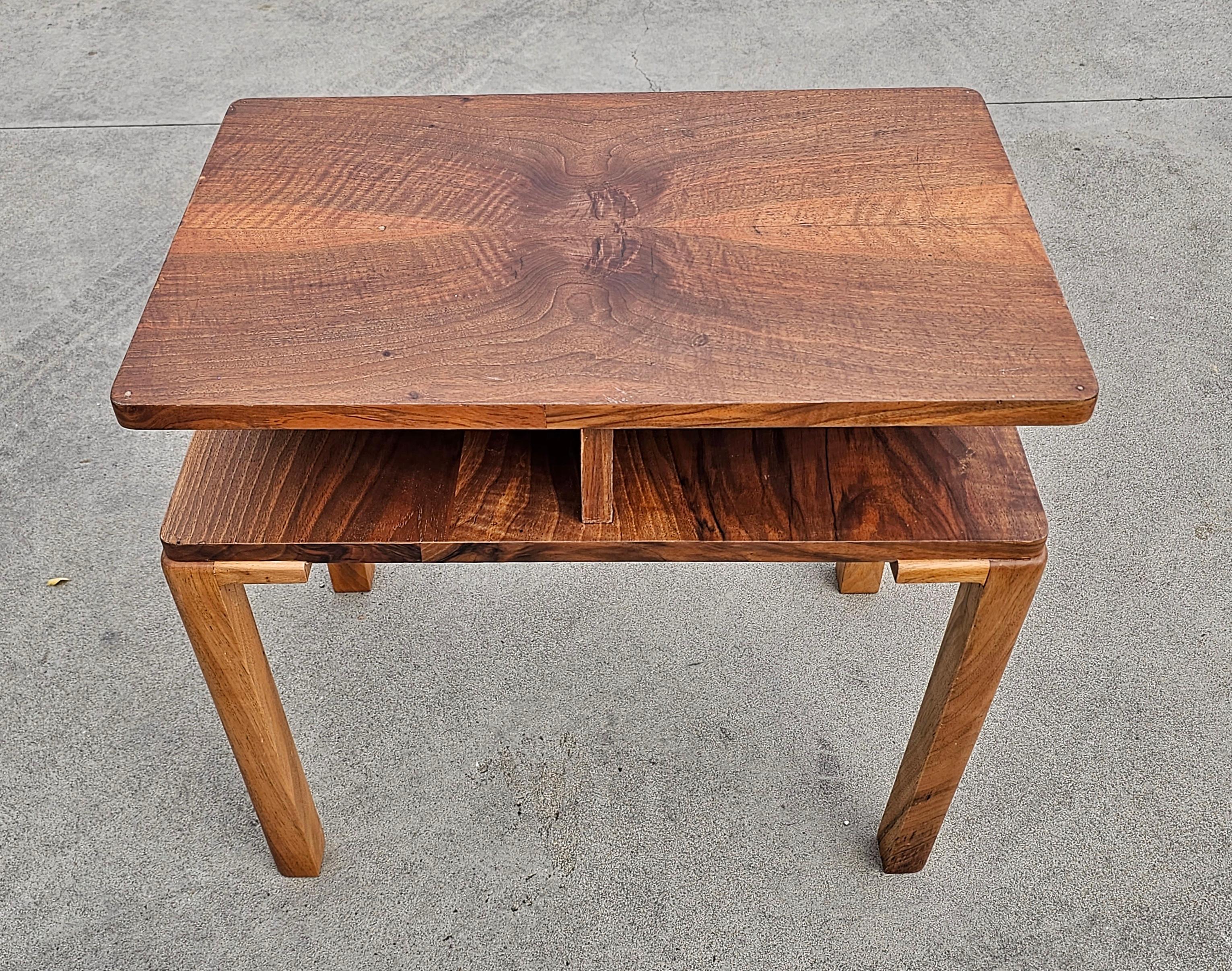 In this listing you will find a gorgeous rectangular Art Deco side table done in walnut, with very rich wood patterns. It i a two-tiered table featuring 4 small compartments on the lower tier and very rare design shape. Made in Austria in