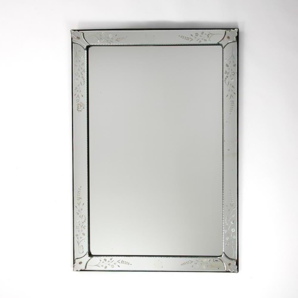 Rectangular Venetian mirror with delicate decoration France 1950s

The object is classic in form and design.
The frame (7.0 cm) is faceted on the outer edge, the inner edge is decorated with a surrounding shell frieze.
The flower and leaf tendrils