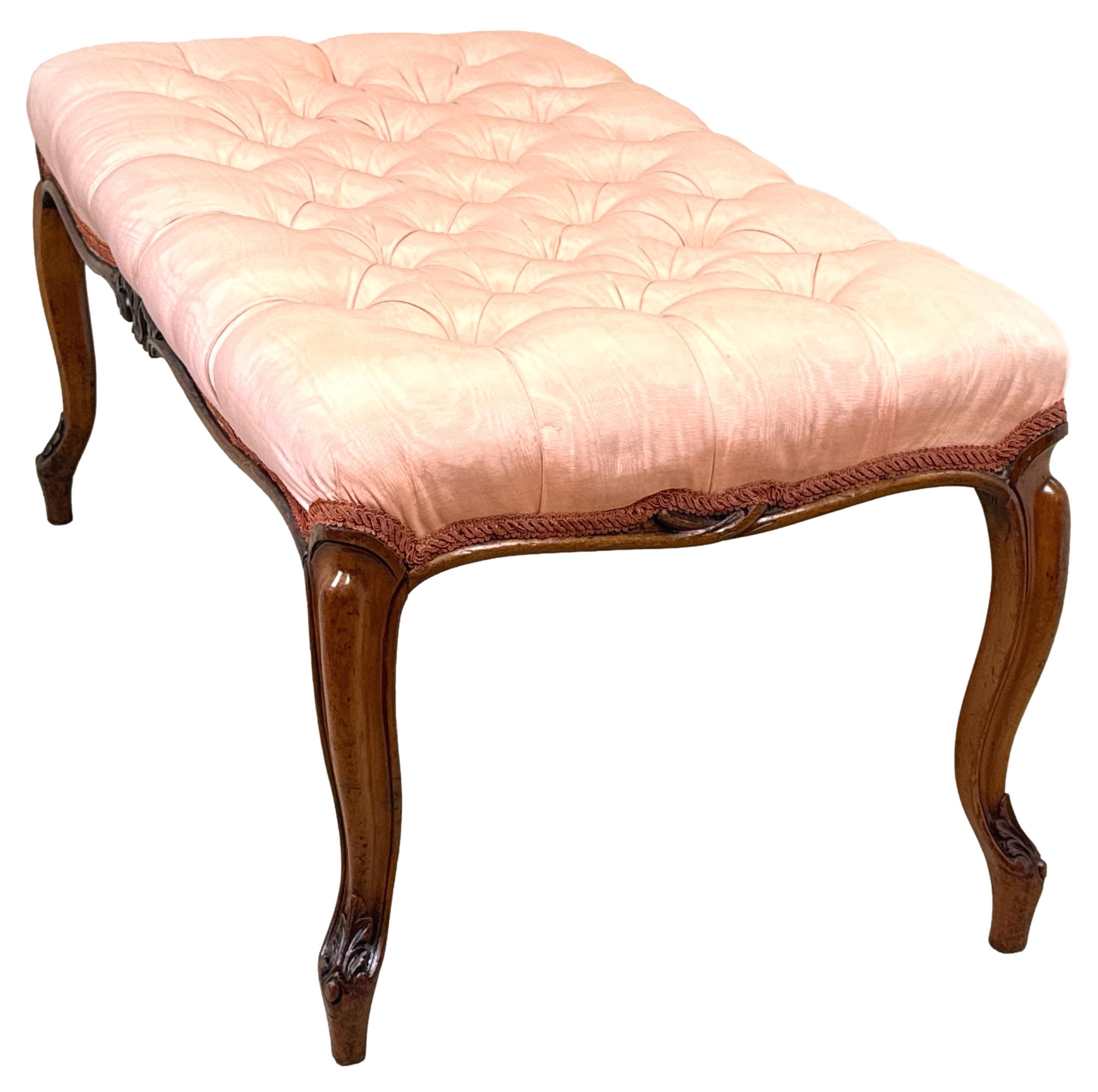 A Very Good Quality Mid 19th Century, Victorian Period, Rectangular Walnut Salon Stool Having Attractive Serpentine Shaped Deep Buttoned Old Damask Covered Seat, Over Moulded Frame With Good Carved Decoration, Raised On Four Elegant And Bold