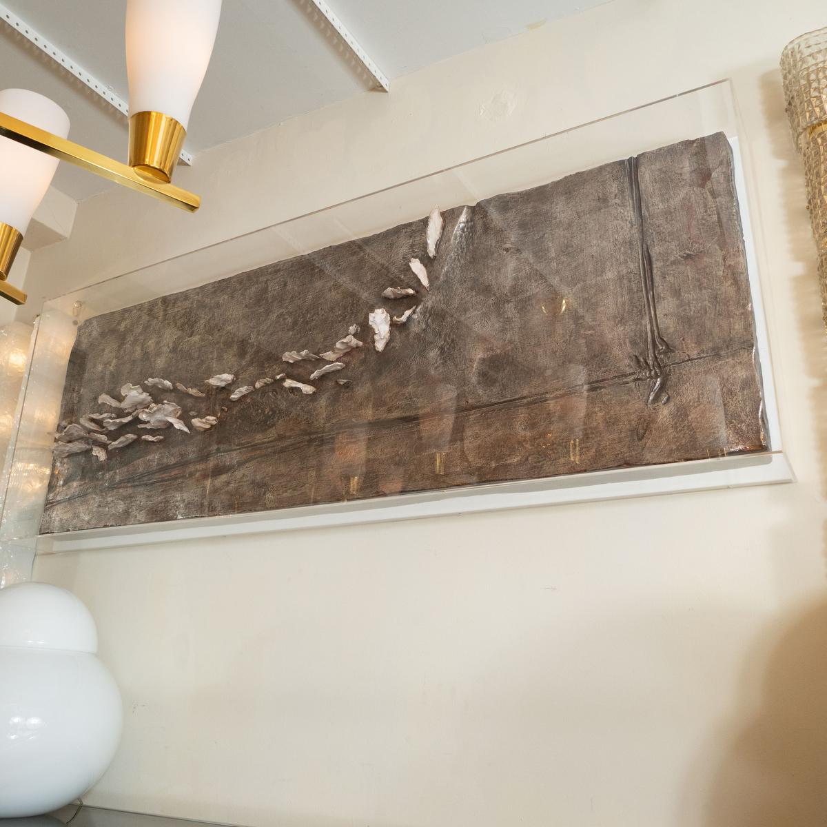 Rectangular metal leaf and plaster wall appliqué encased in acrylic by Nicola Perilli.