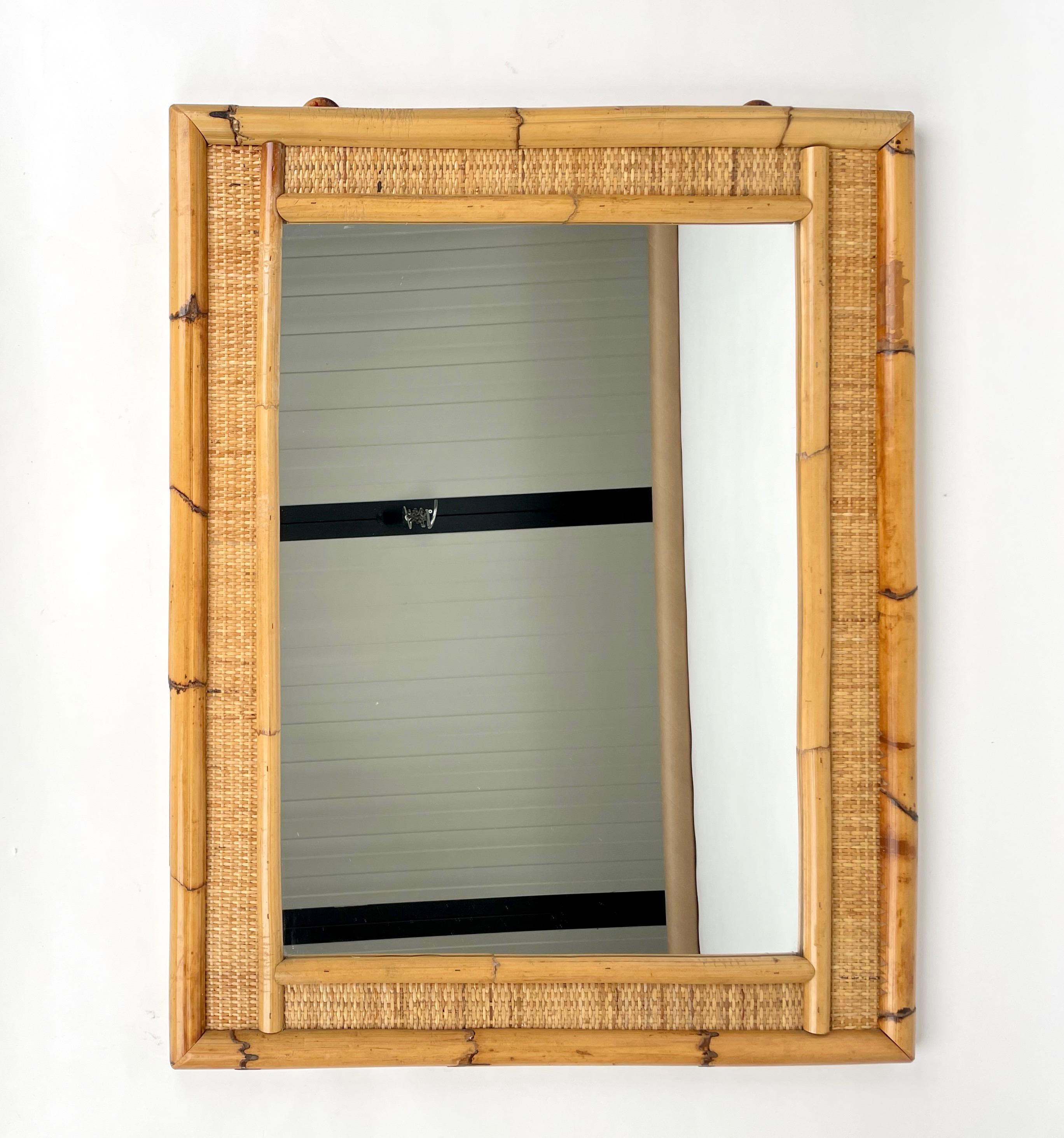 Rectangular wall mirror framed by bamboo and wicker. Made in Italy in the 1970s.