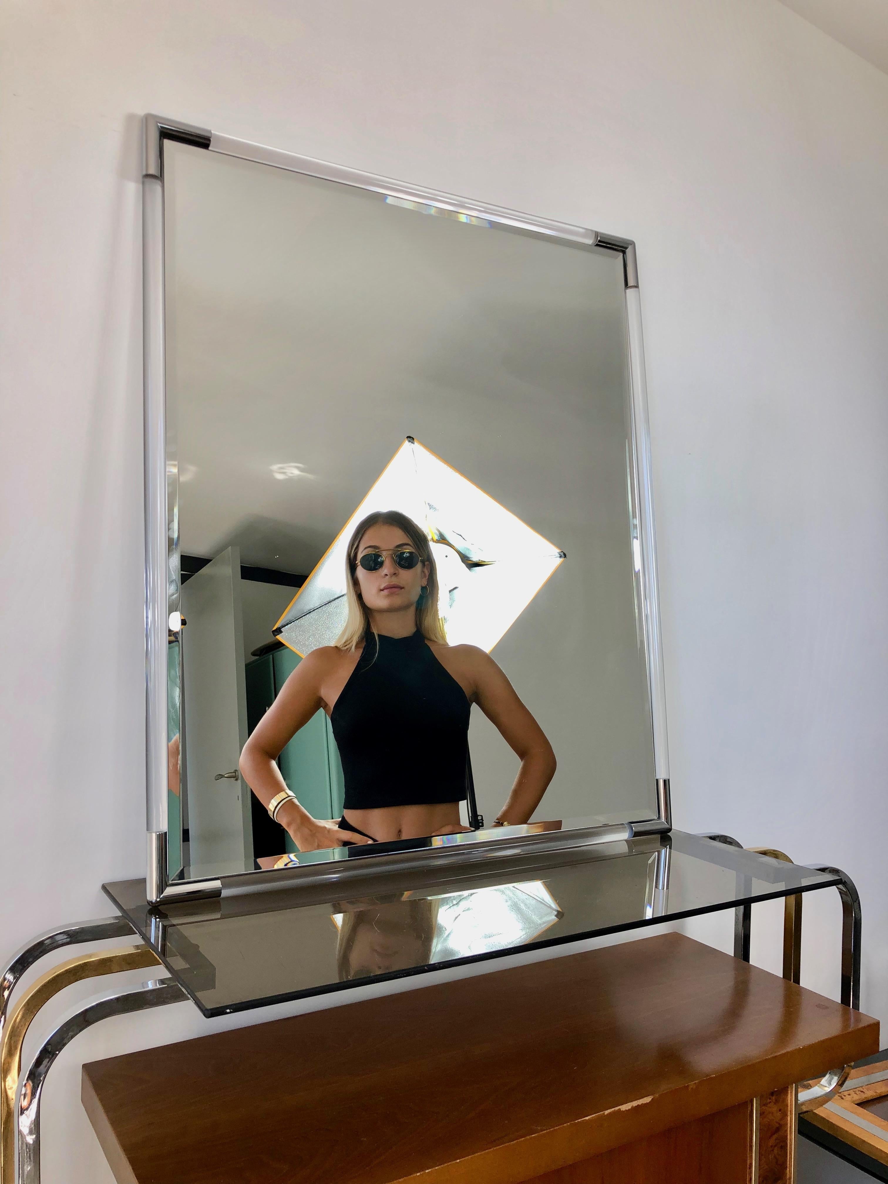 Wall mirror featuring a Lucite frame with silver corners made by Eclisse (signed), Italy, circa 1970.