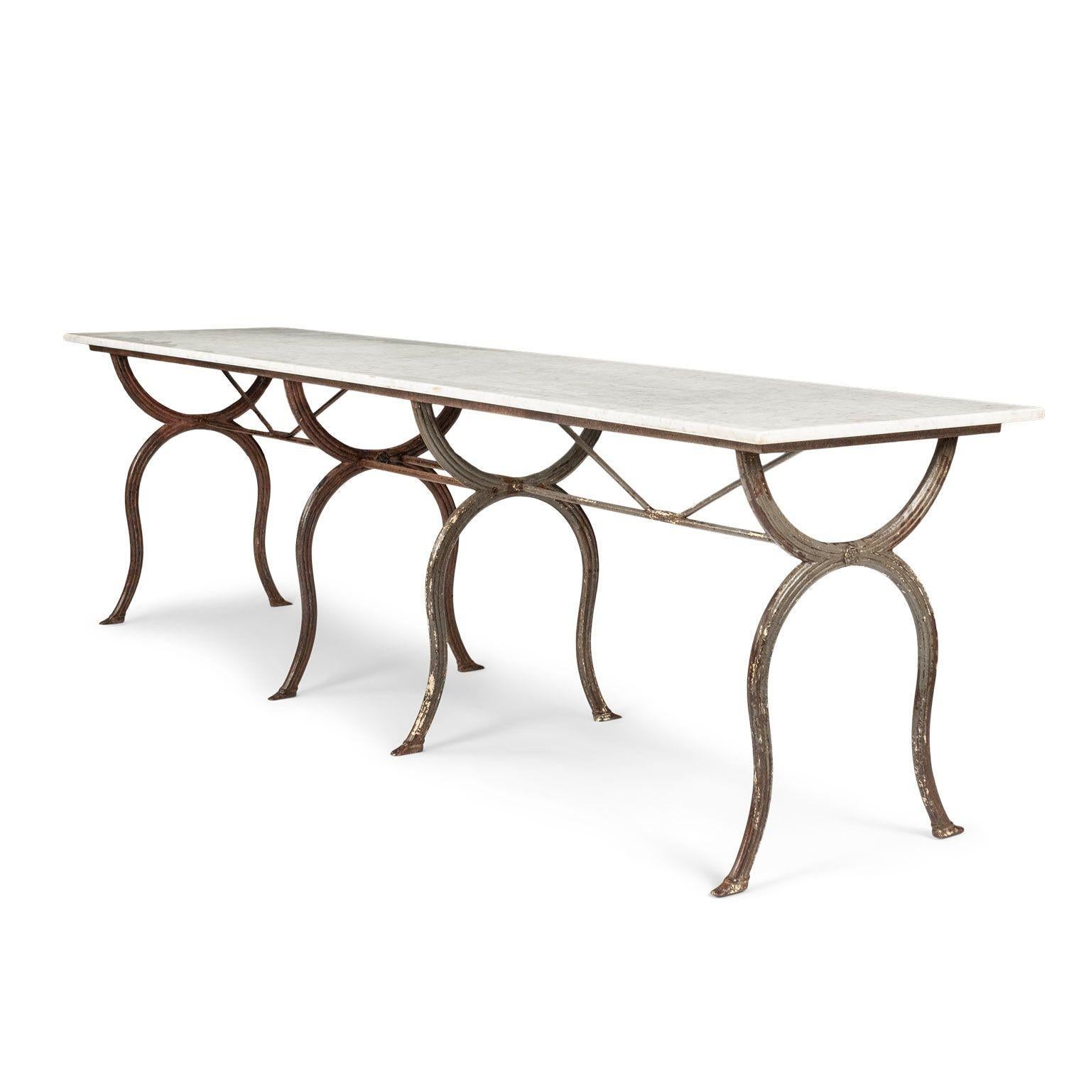 Rectangular white marble top iron base table, made in France during the turn of the 19th-to-20th century. Graceful reeded base with remnants of early white and dark gray paint supports white marble top. Medium and light veins of gray adorn the white