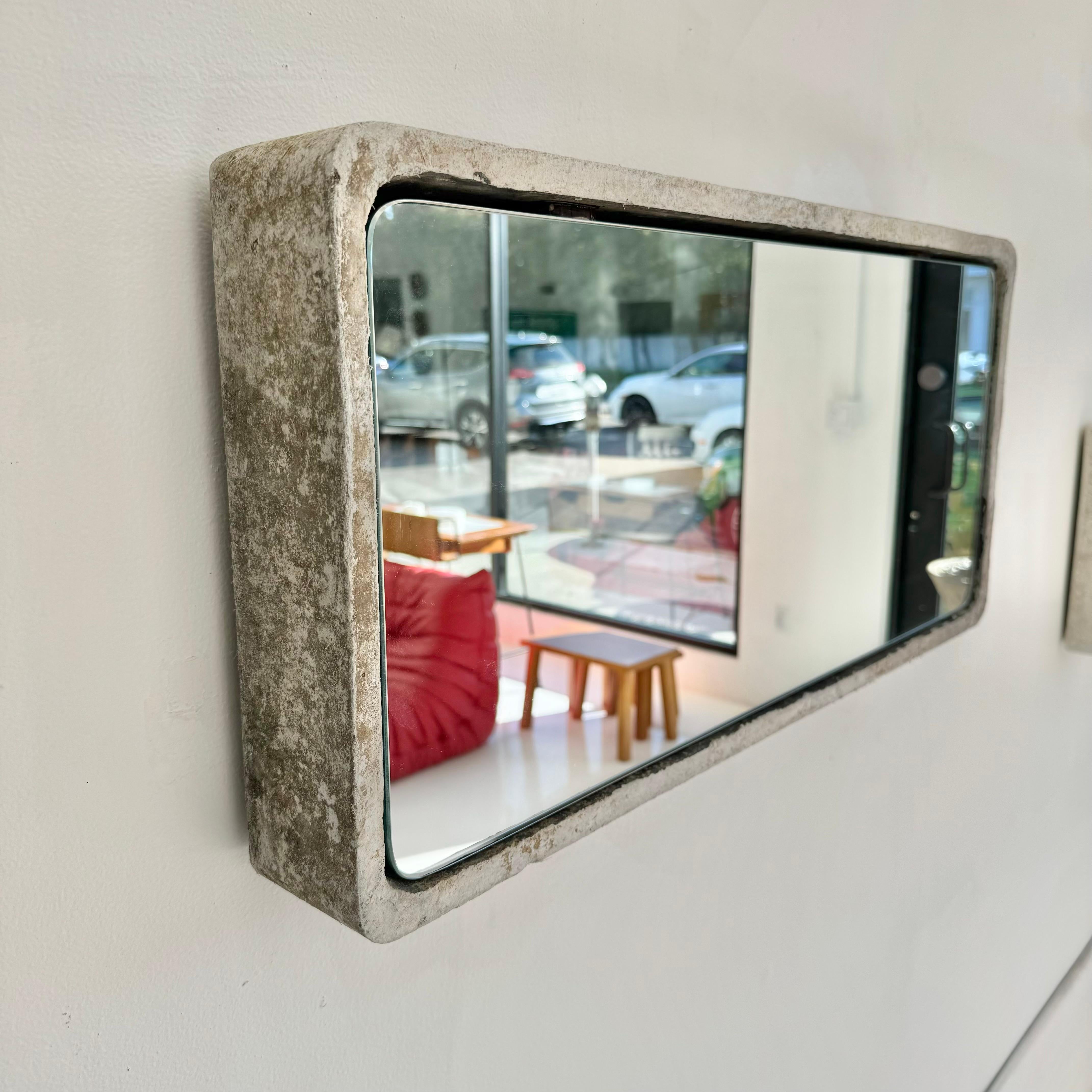 Gorgeous rectangular Willy Guhl concrete mirror. Substantial concrete vessel originally produced at the Eternit factory in Switzerland in the 1960’s. Thick concrete lip. Custom mirror professionally hand cut and added recently. Beautiful patina as