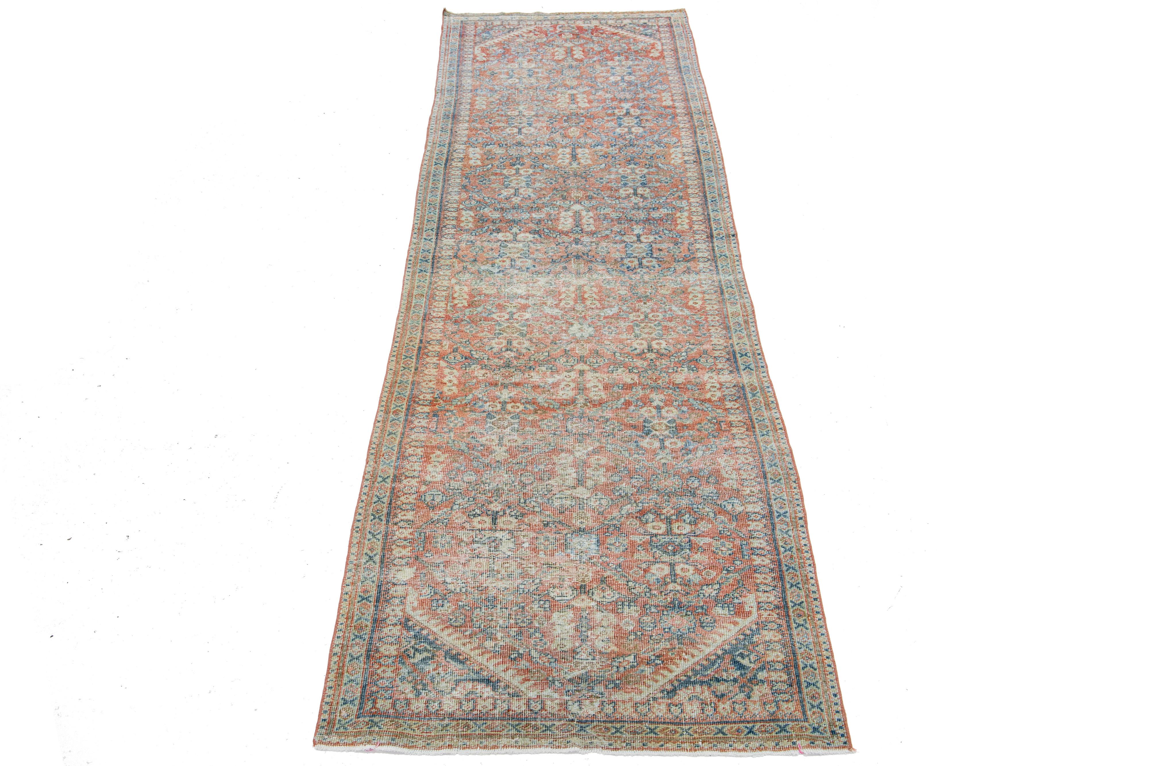 This 1920s mahal wool rug boasts a red-rust main field, highlighted by blue, beige, and brown in an all-over floral pattern, creating a classic look.

This rug measures 3'2