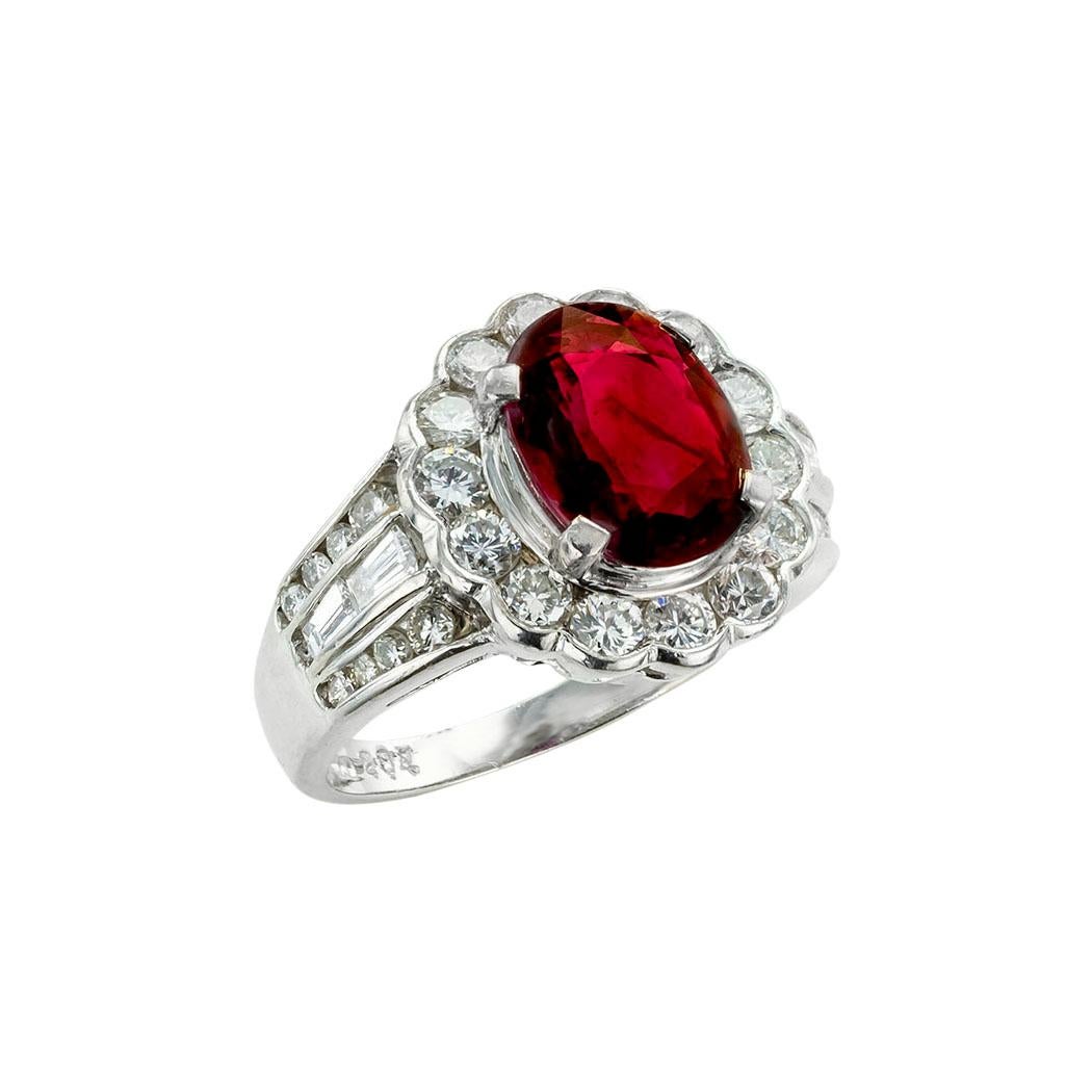 Ruby and diamond platinum ring. *

ABOUT THIS ITEM:  #R-DJ630A. Scroll down for specifications.  A larger, standout, ruby displaying an amazing shade of red figures as the centerpiece of this beautiful ring.  The slightly contemporary design has a