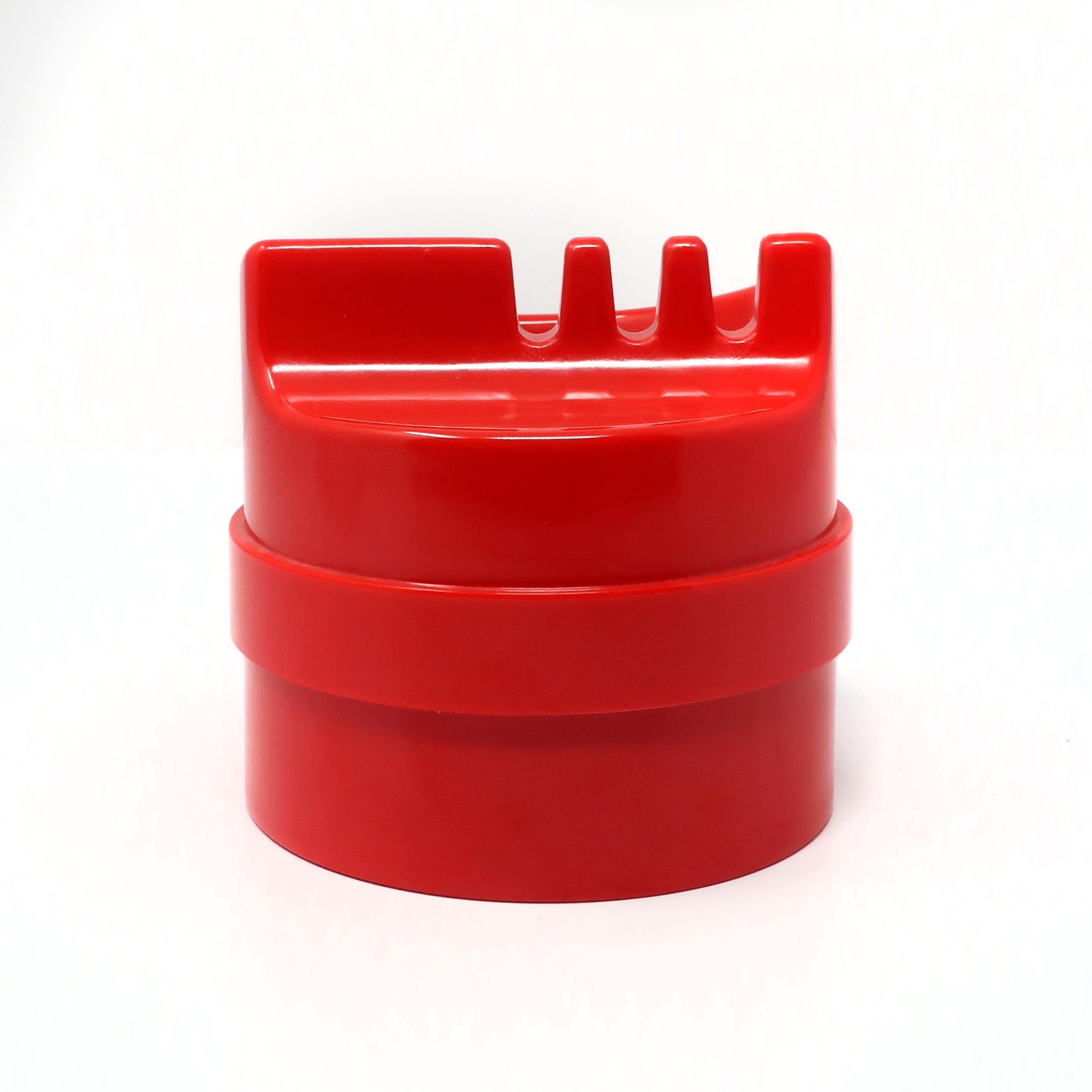 Originally designed in 1970 and produced by Kartell in 1973 two years after designer Joe Colombo's death, the Kartell 4630 Roto/Rotocenere ashtray is Colombo at his finest. Red plastic construction with beautiful lines and a thoughtful design that