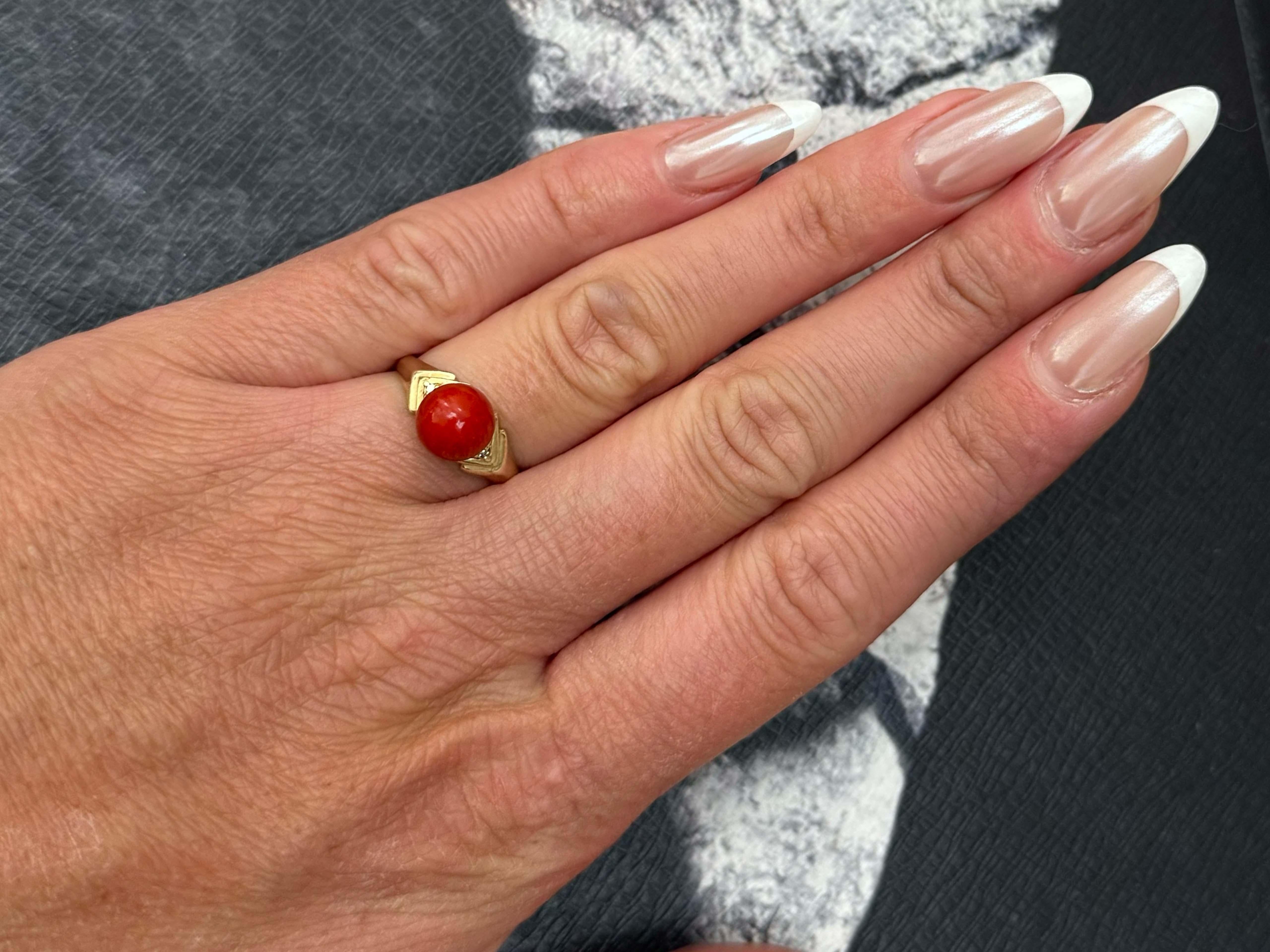 Item Specifications:

Metal: 14K Yellow Gold

Ring Size: 6.25 (resizing available for a fee)

Total Weight: 2.9 Grams

Aka Coral Specifications:

Shape: Sphere

Coral Diameter: 8 mm

Diamond Count: 2 round brilliant cut 

Diamond Color: J-K

Diamond