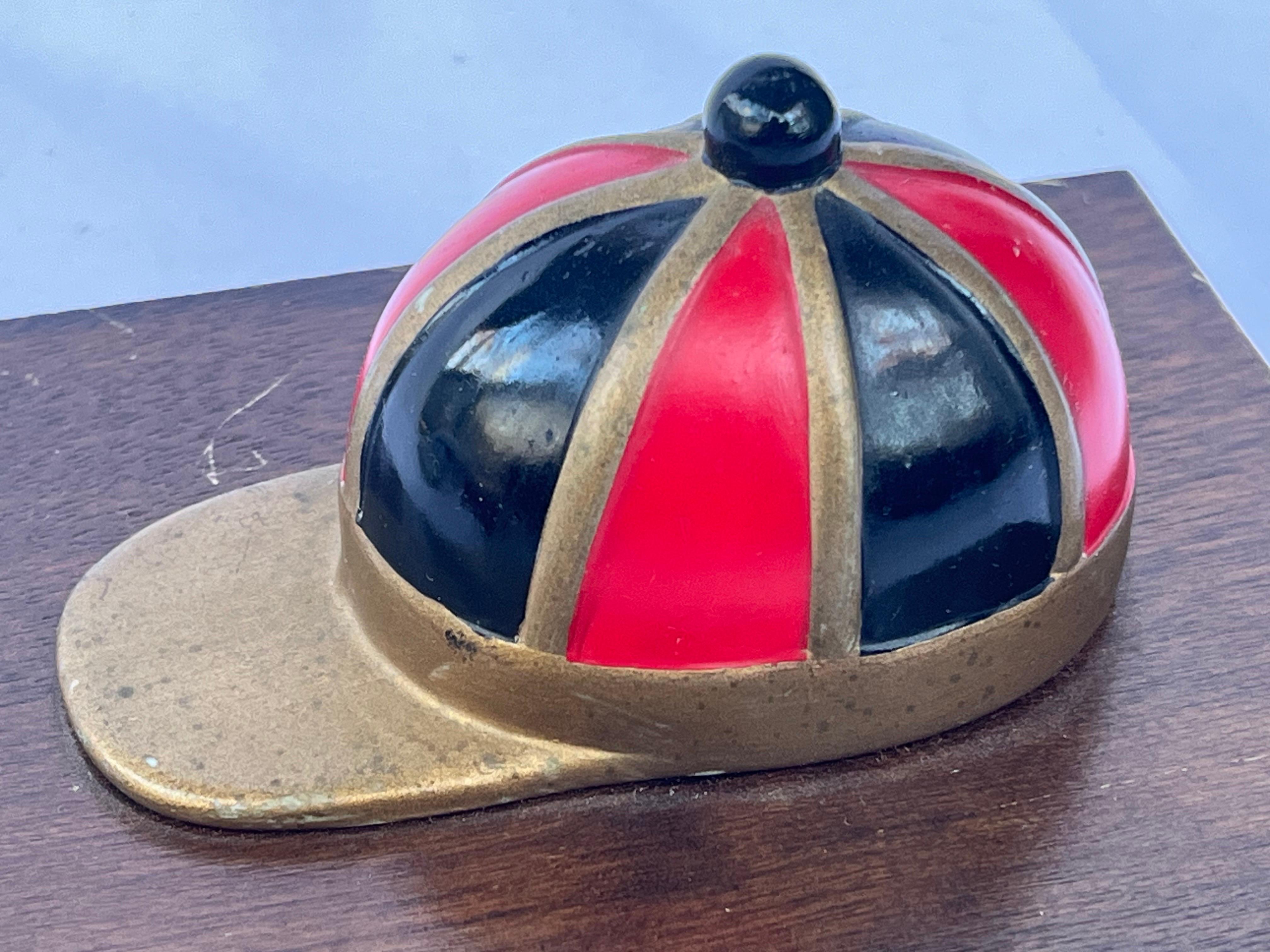 A vintage double playing card box. Perfect for those nights when you get together with your squad for a few hands or poker or gin rummy or go fish. The brass and enamel jockey cap is the perfect accessory to this box. Maybe not the red and black