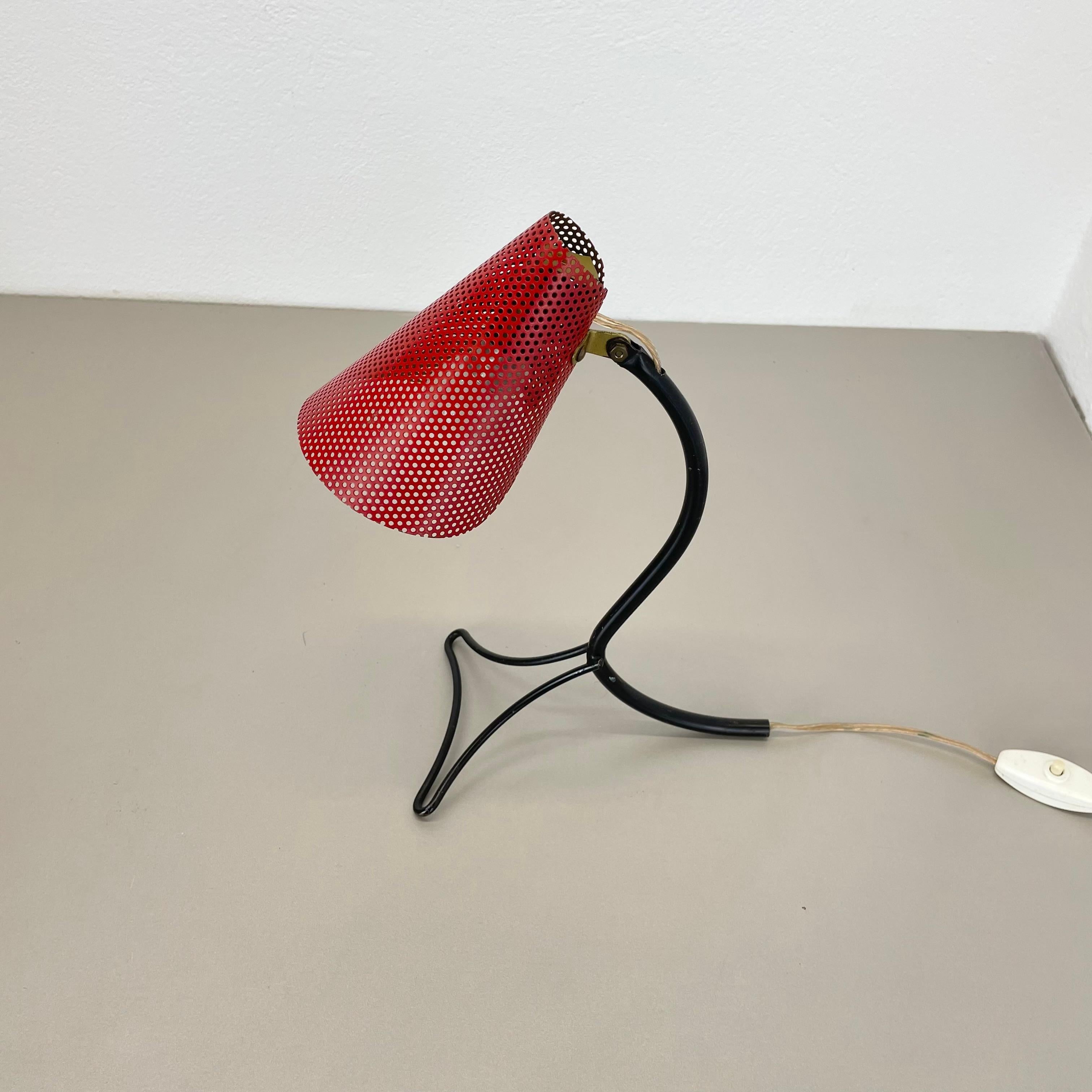 Article:

table light


Producer:

Origin France in Style of MATHIEU MATEGOT


Age:

1950s


This modernist table light was produced in France in the 1950s. It is made from solid metal with nice perforated red shade in authentic vintage condition..