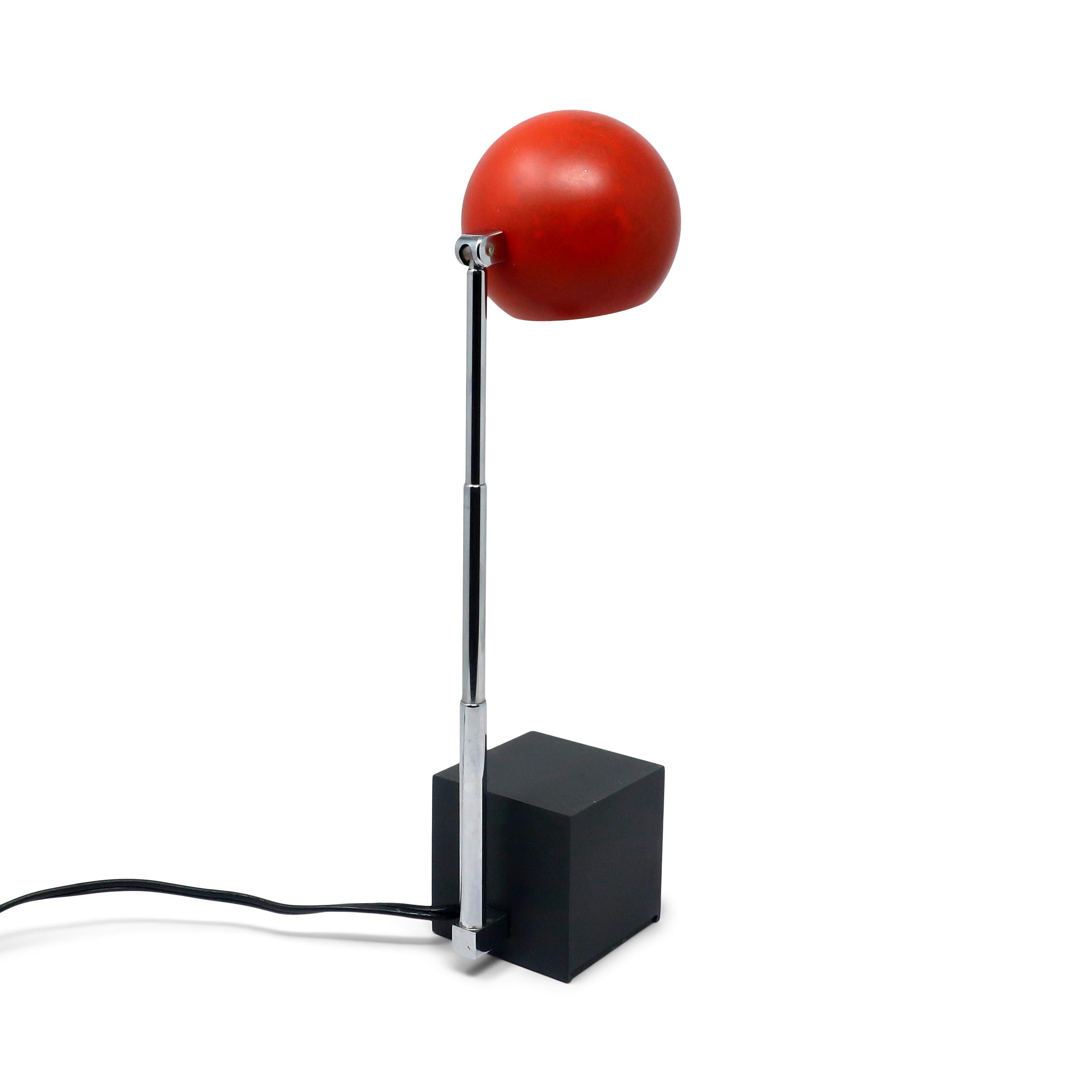 A mid-century modern Lytegem desk/task lamp by Michael Lax for Lightolier (1965) with a black base, red shade and extendable chrome stem, with switch for two light intensities.  Can be found in the permanent collection of the Museum of Modern Art