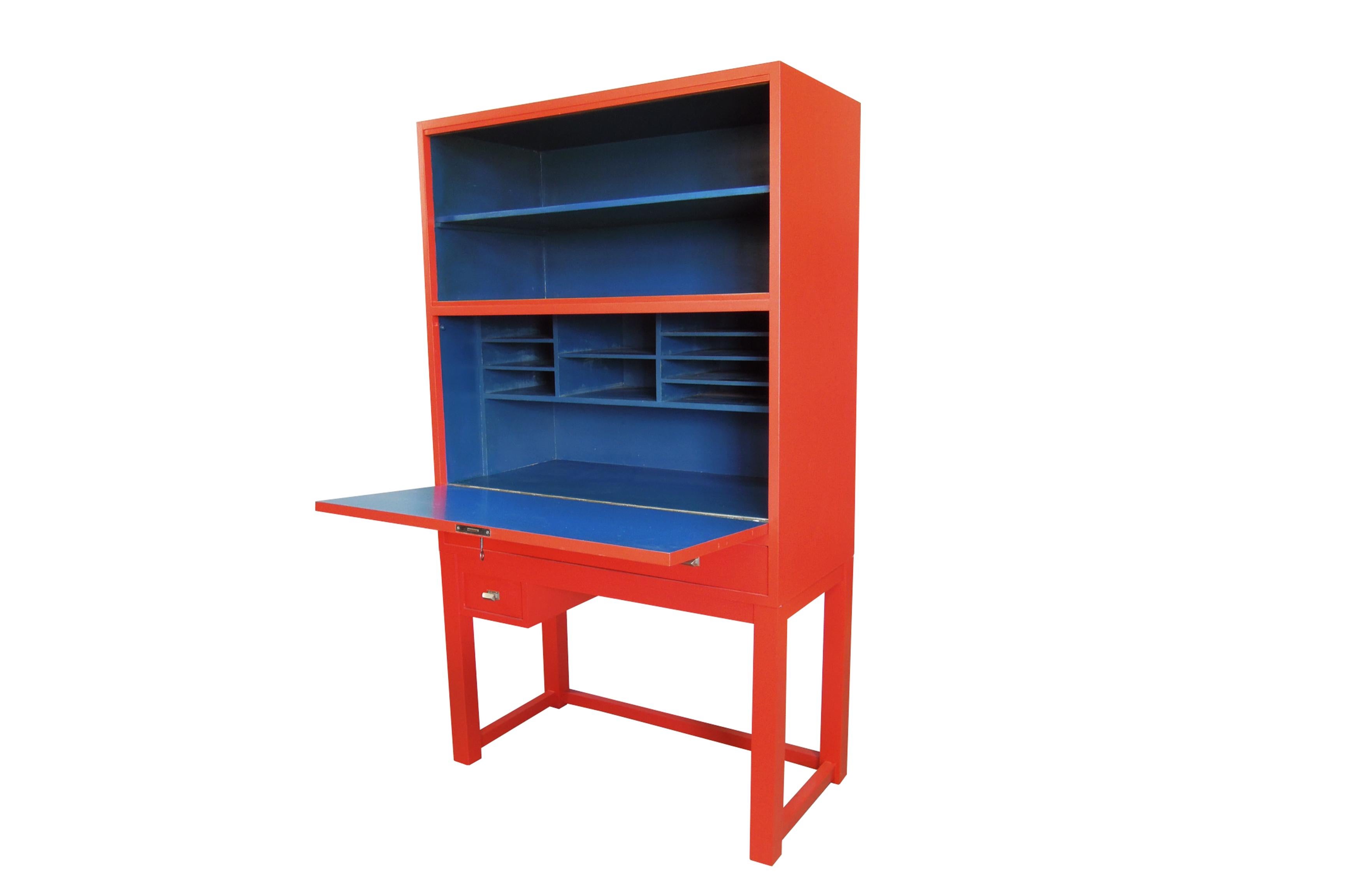 The red and blue colors are the original combination. The exterior of the cabinet is bright red with a vivid blue interior, creating an impactful visual contrast. No-one can miss the oriental design influence on this unusual tall modernist cabinet;