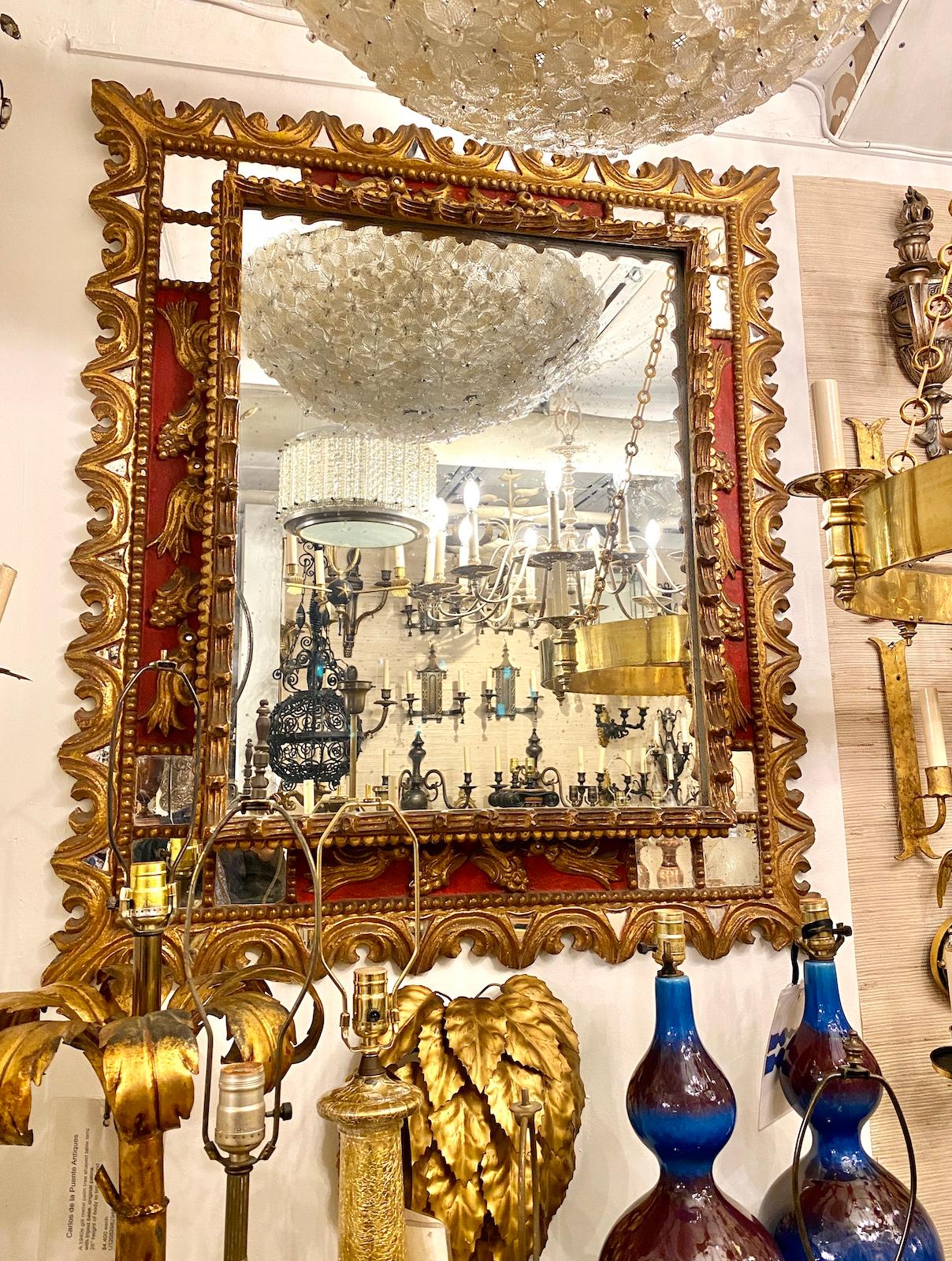 A late 19th Century Spanish Colonial mirror with gilt and painted finish and mirror insets in frame.

Measurements:
Height: 43
