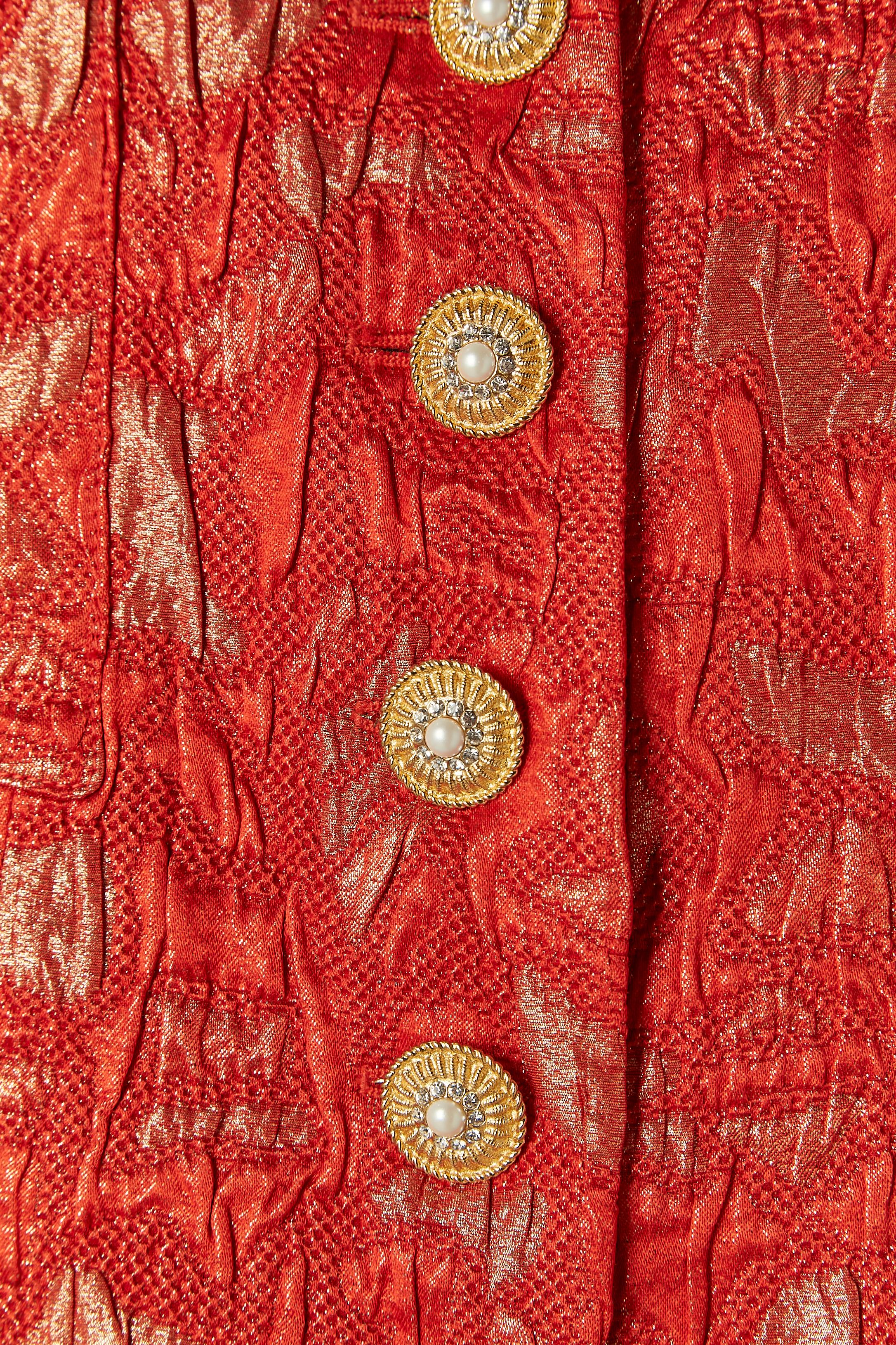 Red and gold brocade evening skirt-suit. 
Main fabric composition: 54% silk, 30% wool, 16% polyester. Rayon lining. 
Jewellery buttons closure on the middle front + one extra button provided. 
Pockets on both side. Shoulder-pad. 
SIZE 6 US / 38 Fr