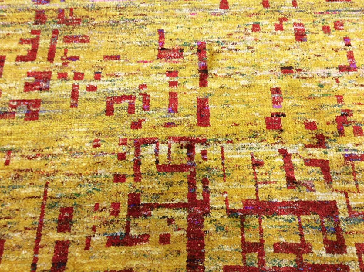 Bold red and gold bring color and warmth to a modern space. Hand knotted wool construction lends durability for high-traffic areas. 

Made in India.