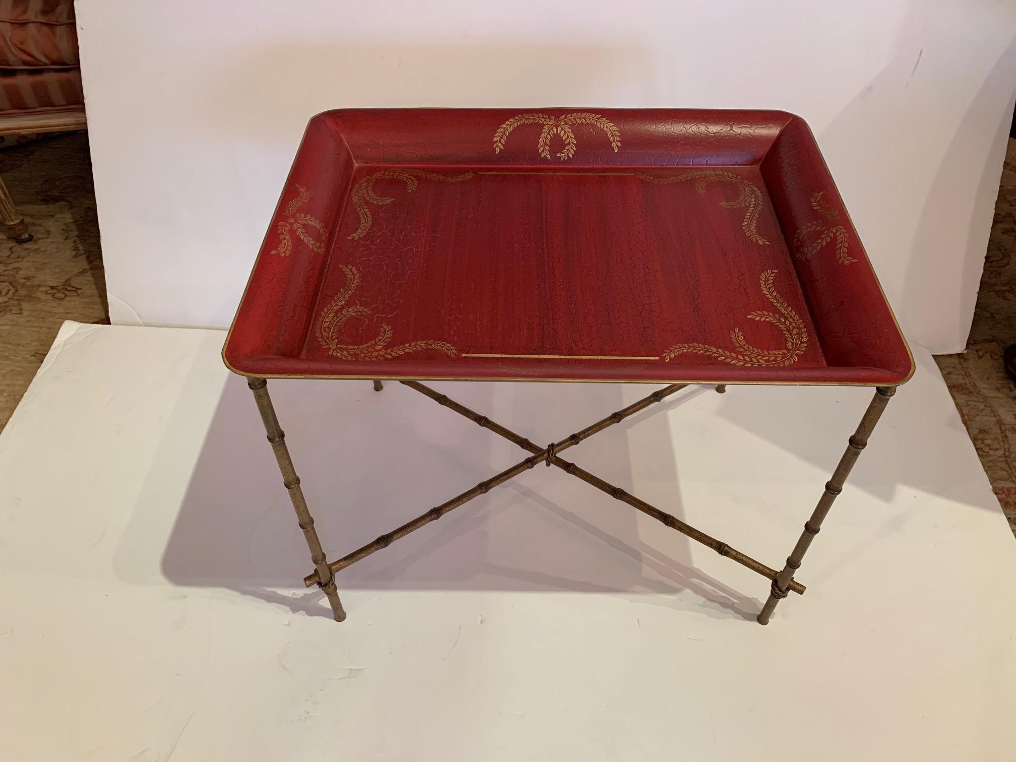 Stunning tray top end table with a rich pop of color having red top adorned with gold and elegant faux gilt bamboo base.