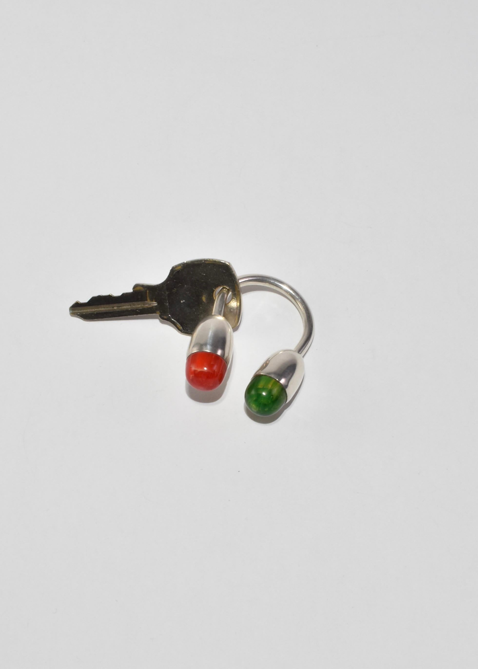 Rare, vintage sterling key ring with red and green bakelite detail and screw closure. Stamped 925.